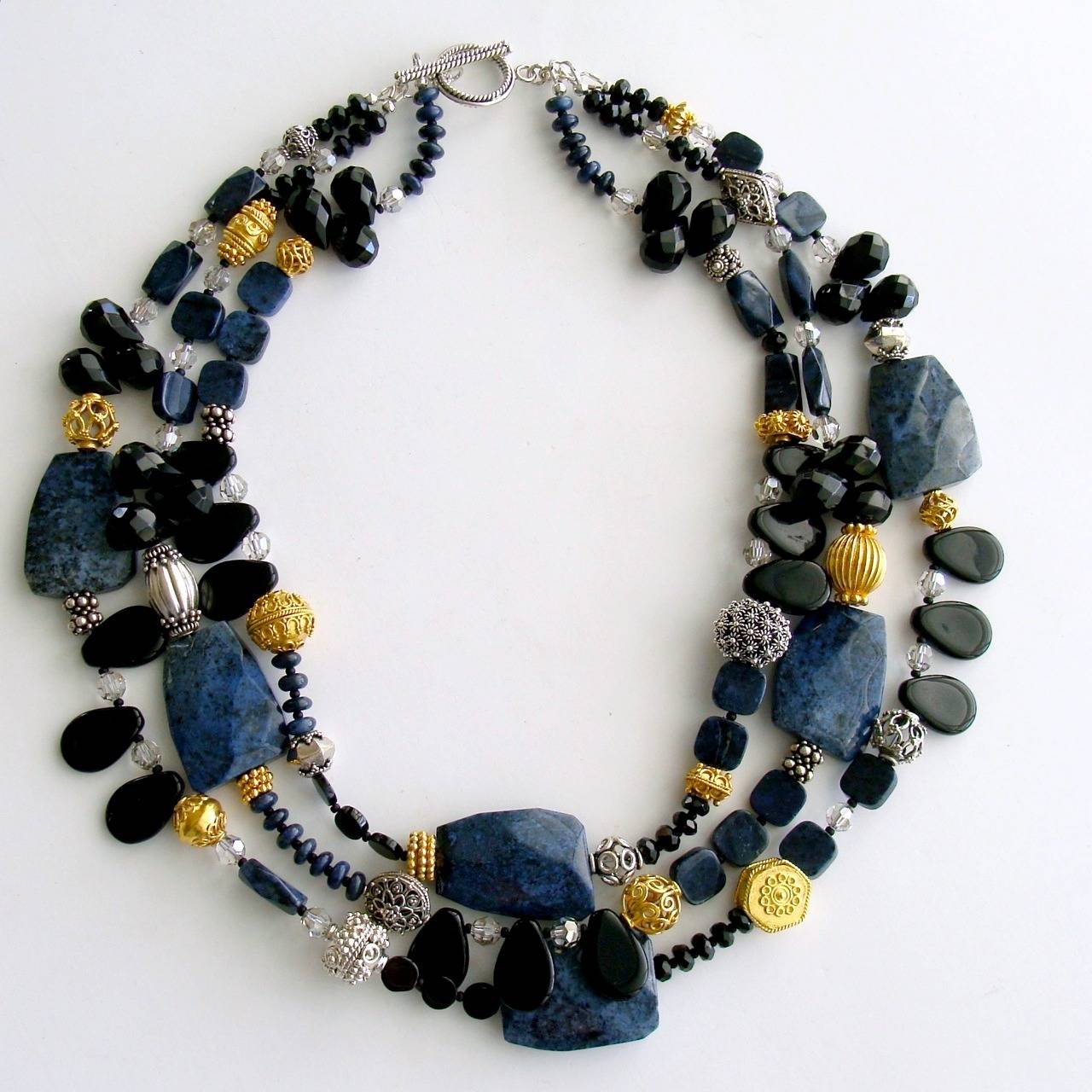 Campbell II Necklace.

A happy marriage of black onyx beads and beautiful denim blue dumortierite faceted nuggets along with a sprinkling of crystal rondelles and mixed metal beads in sterling silver and rich 24k gold vermeil - makes this possibly