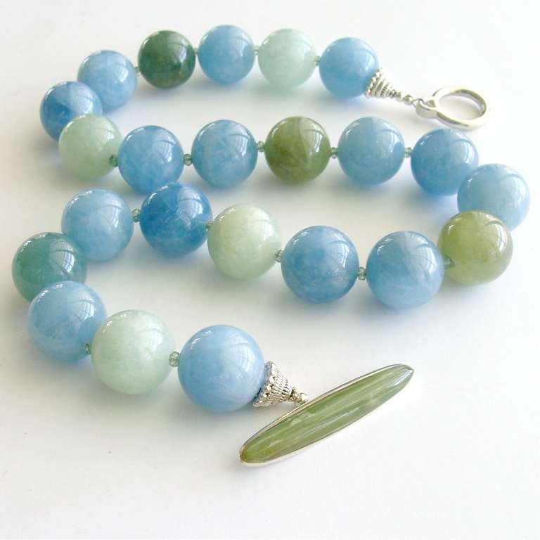 Stunning 18mm watery aqua blue and spring green polished aquamarine beads, are gently separated by sparkling prasiolite rondelles.  The spring green serpentine toggle clasp can be worn off center as a unique focal point, or placed at the back of the
