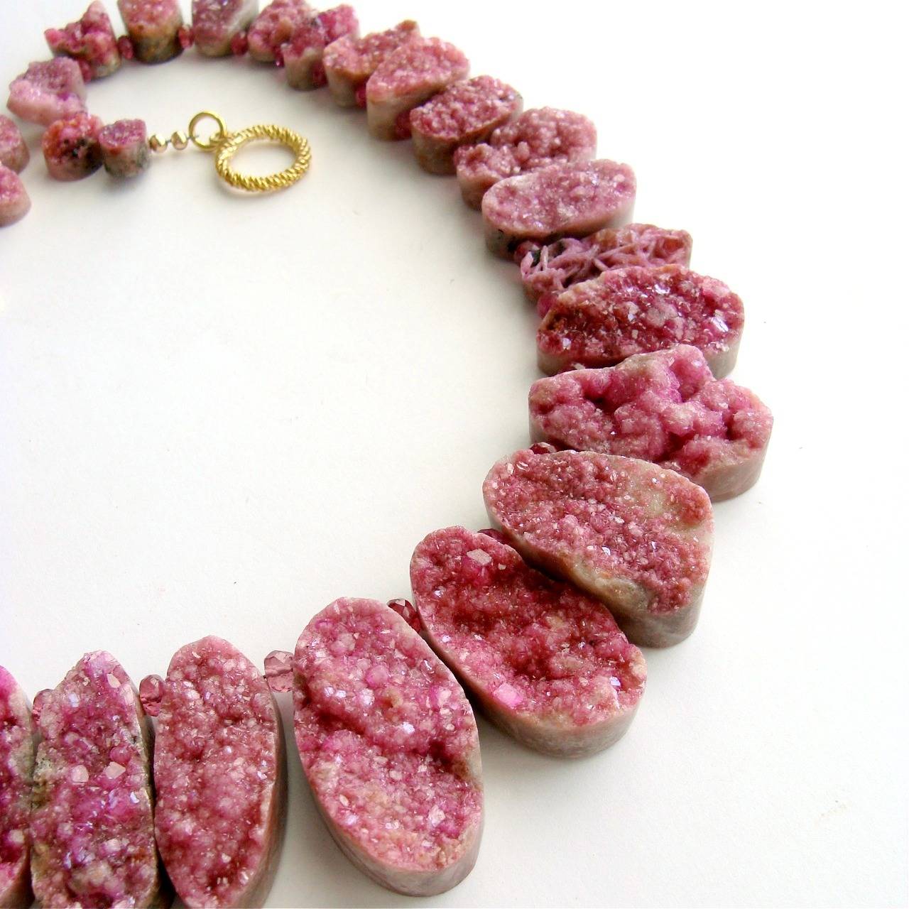 Cherie Necklace.

Dozens of amazing pink sugar-dusted cobalto calcite druzy teardrops have been suspended between faceted pink sapphires to create this spectacular specimen necklace.  The unique  teardrops graduate in size from 10.6mm to 34.8mm