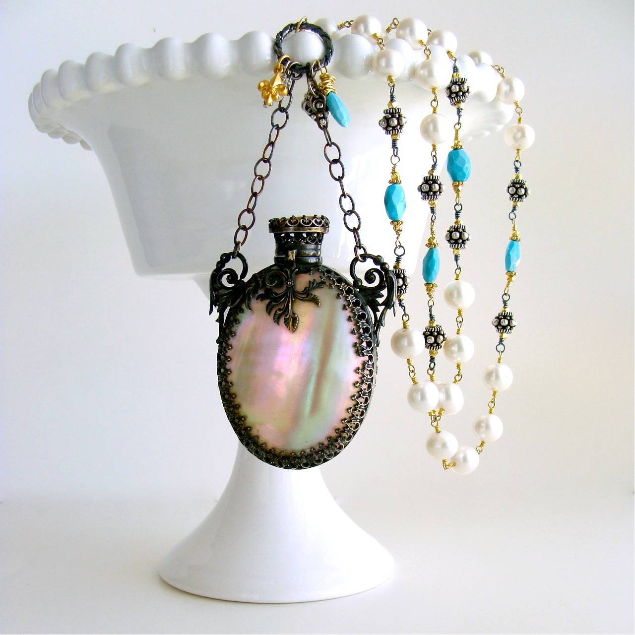 Alana Necklace.

A stunning Mother of Pearl Victorian scent bottle - embellished with  oxidized silver cartouche - has now become the featured pendant of this new necklace design.  The original finger loop and chain have been replaced, as they
