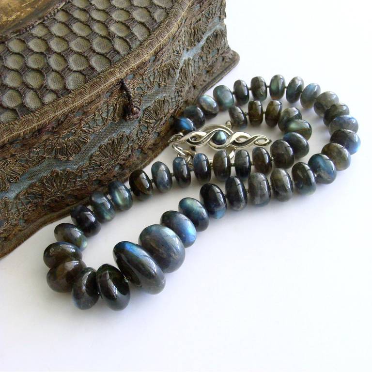 Lyrica II Choker Necklace - 
This stunning statement necklace, which is comprised of an entire graduated strand of enormous labradorite rondelles (Approximately 750 Carats), has been kept as simple as possible to allow the beauty of the flashing