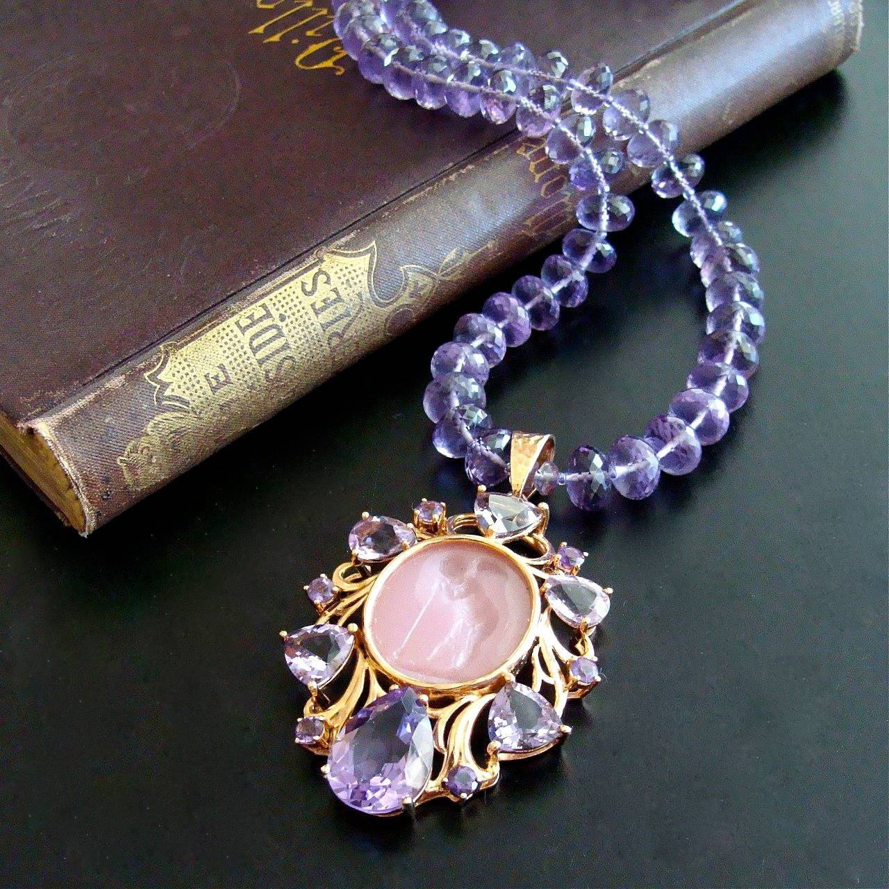 Montepulciano Choker Necklace.

A choker style necklace of sparkling micro faceted amethyst rondelles is the elegant backdrop for this remarkable Venetian glass intaglio pendant choker necklace.  The setting of the pendant consists of multiple