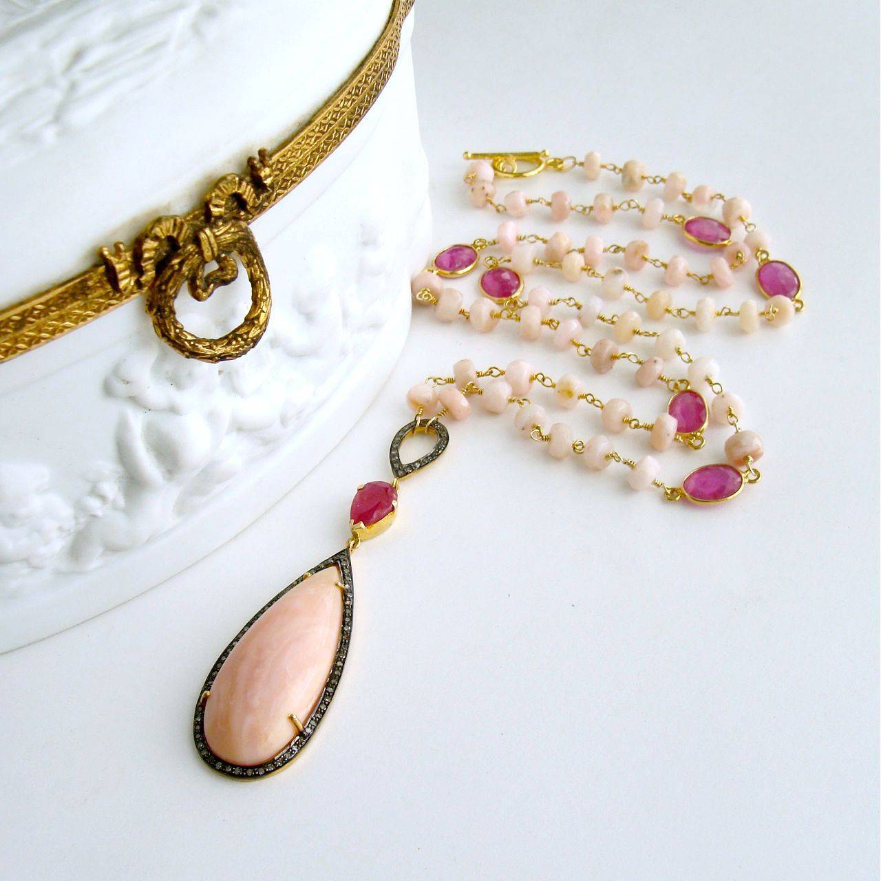Lisette Necklace.

Ballet pink Peruvian pink opals have been hand linked in gold vermeil and intercepted with bezel set pink sapphire connectors to create this ultra feminine layering necklace.  A striking teardrop pendant of Peruvian pink opal