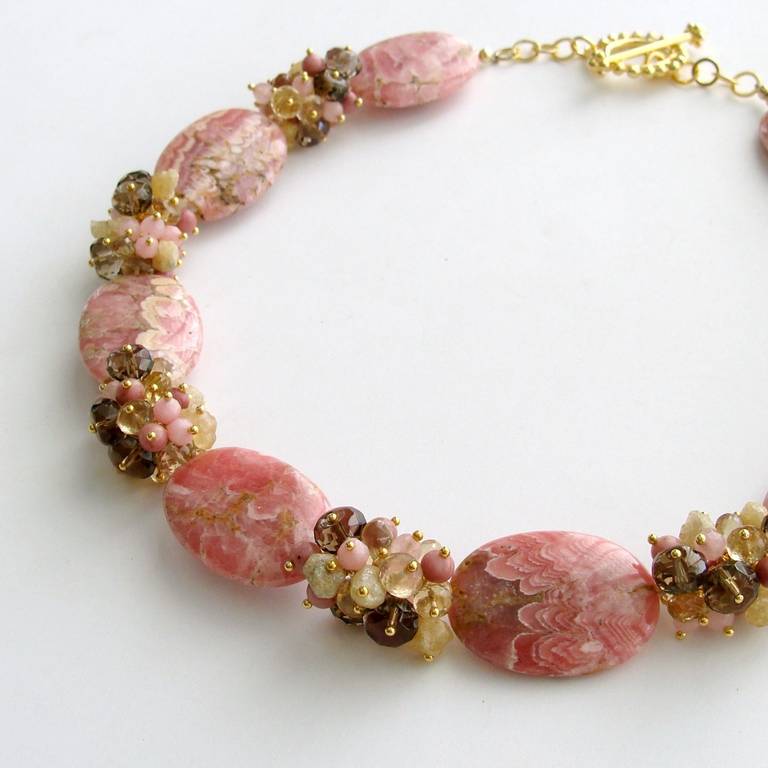Unique Missoni-like stripe rhodochrosite slices in honeysuckle pink, bamboo, coffee liqueur and nougat colors are juxtaposed with generous clusters of champagne citrine, rhodonite, pink jade, raw  Herkimer diamond nuggets and smokey quartz.  Each of