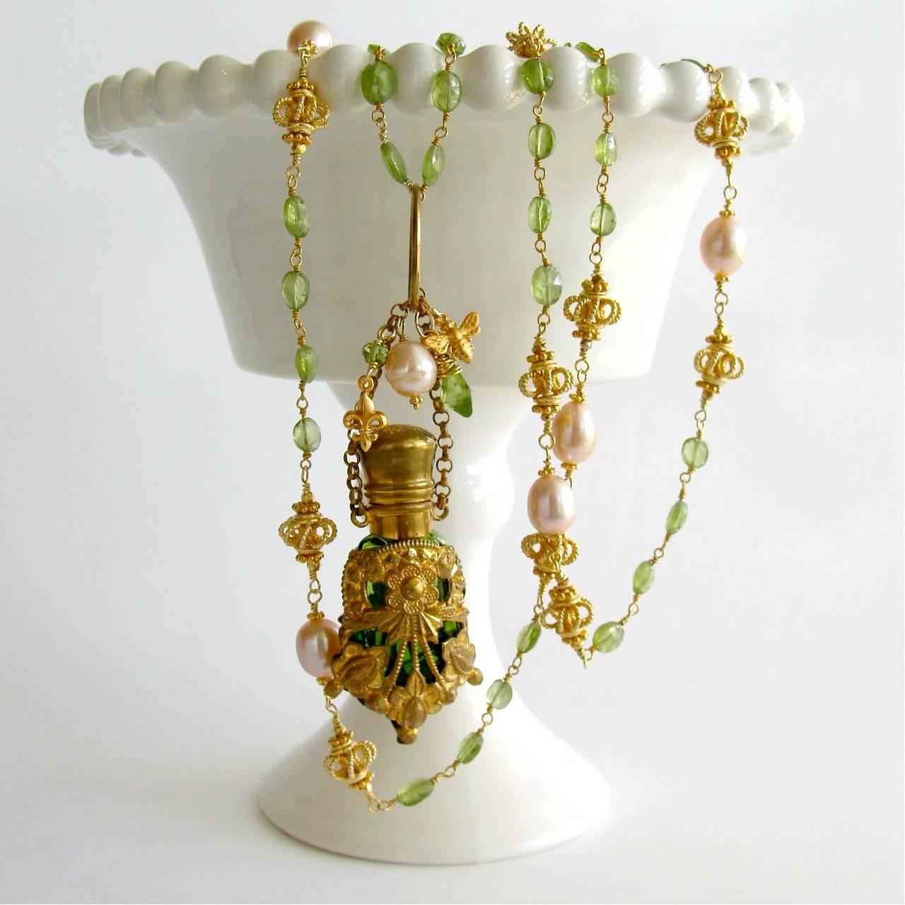 Juliana Necklace.

A remarkable peridot green glass Victorian scent bottle (c. 1900) - embellished with gold gilt floral and cartouche casing - has now become the featured pendant of this new necklace design.  Although the glass stopper is
