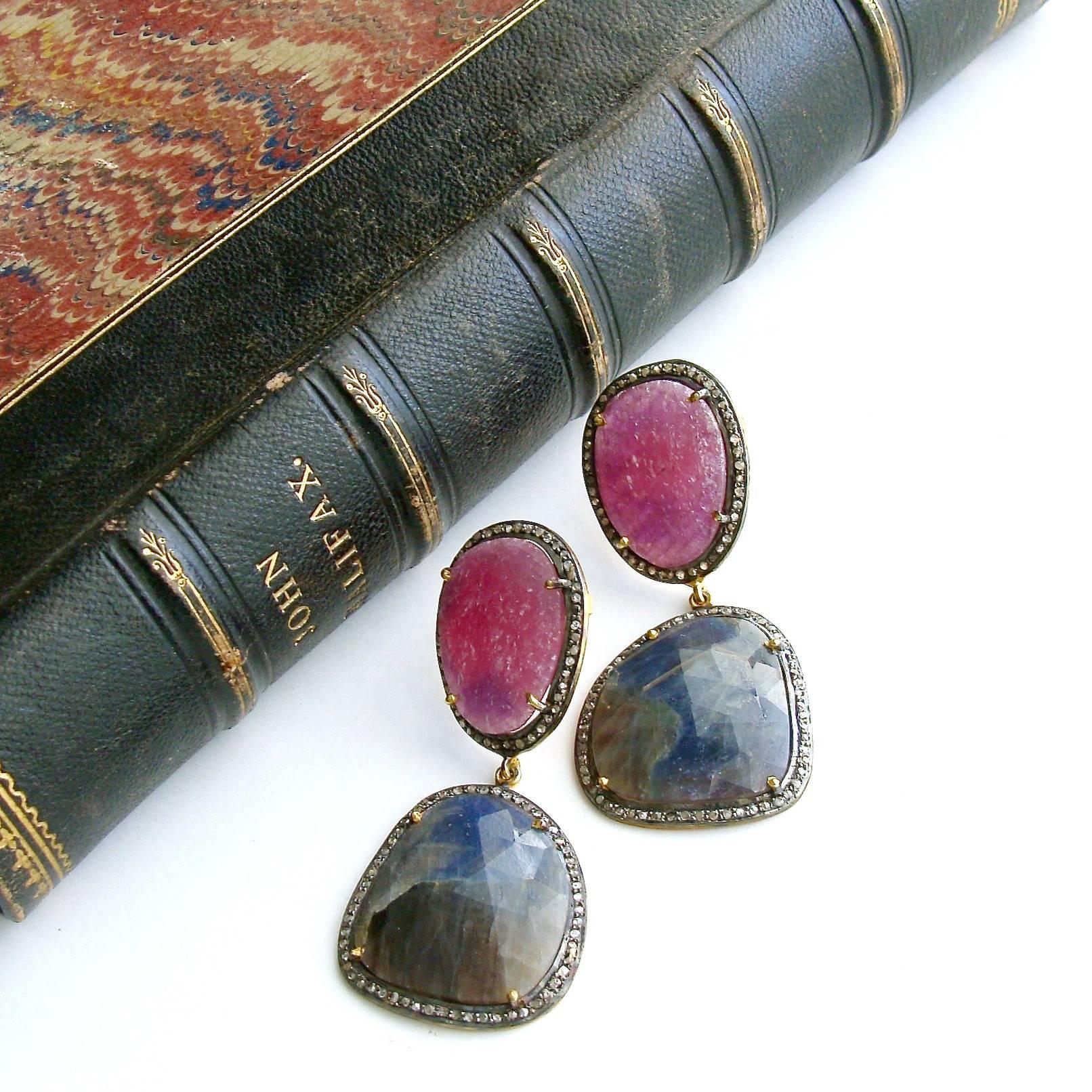 Katie Earrings.

A classic  color combination of raspberry pink and denim blue faceted sapphire slices, encircled with pave diamonds - has created a timeless design that will certainly elicit admiring glances from fashionistas everywhere.  The 