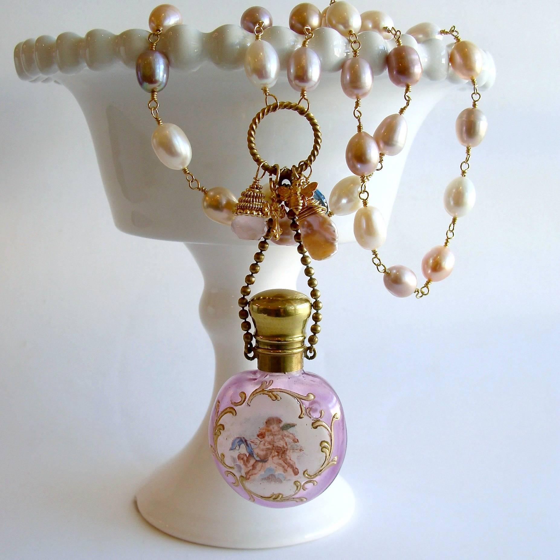 Violetta Necklace.

A stunning violet glass Victorian scent bottle (circa 1880), replete with a cartouche embossed frame of froliciking cherubs - has now become the featured pendant of this new necklace design.  The original glass stopper remains