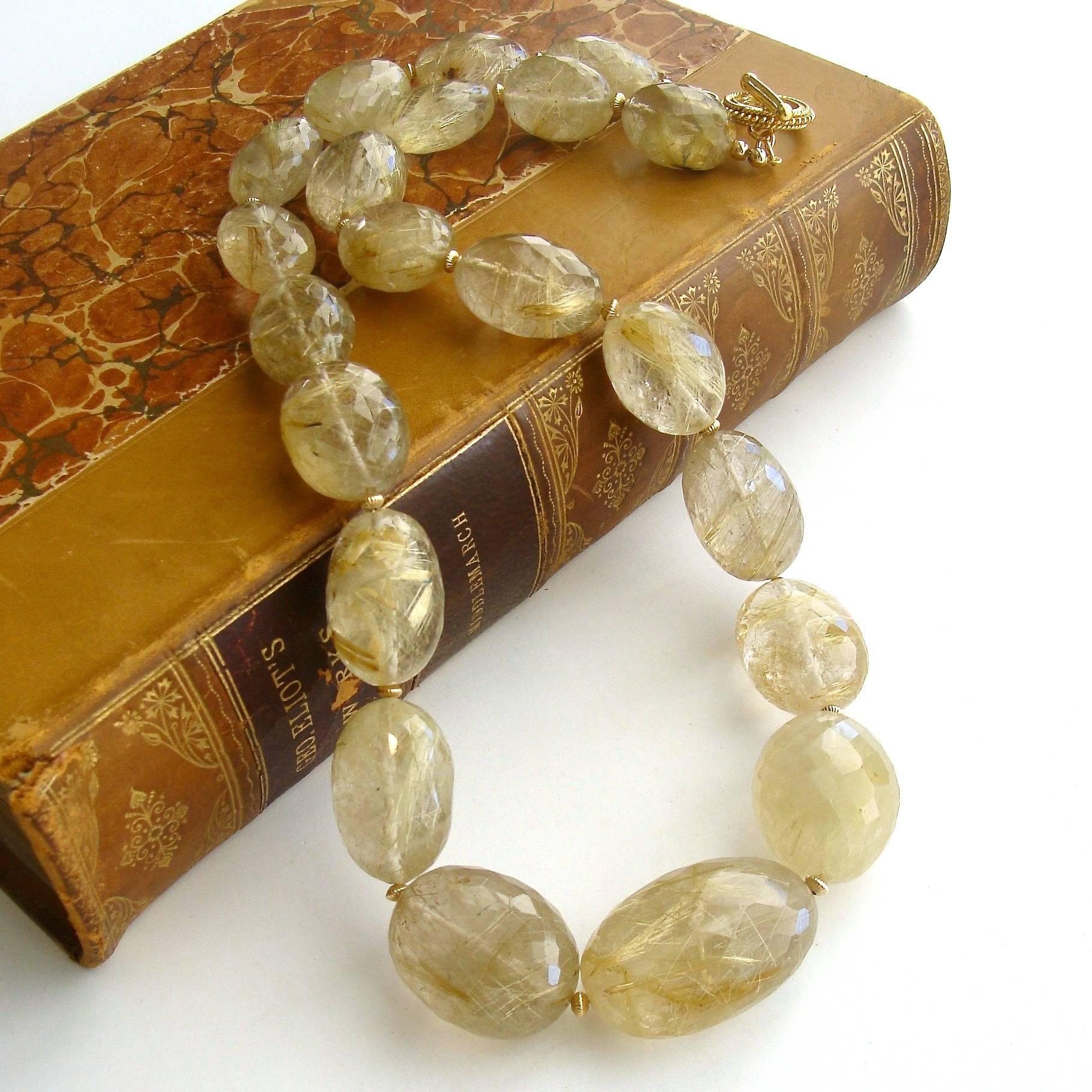Lisa Necklace.

A breathtaking suite of faceted rutilated quartz oval beads (811.45 cts.), separated by fluted goldfilled rondelles, is the focus of this ethereal fairy tale necklace.  The golden needle-like straws encased within the clear quart