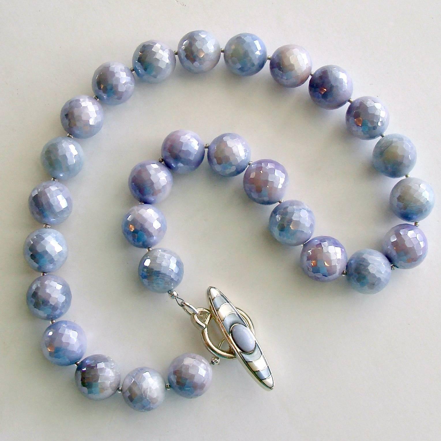Violet Necklace.

These jaw dropping 15mm faceted mystic lavender moonstone beads are certain to call attention to your exquisite taste.  The gentle shading of these stones from lavender to violet to periwinkle blue is the hallmark of an elegant