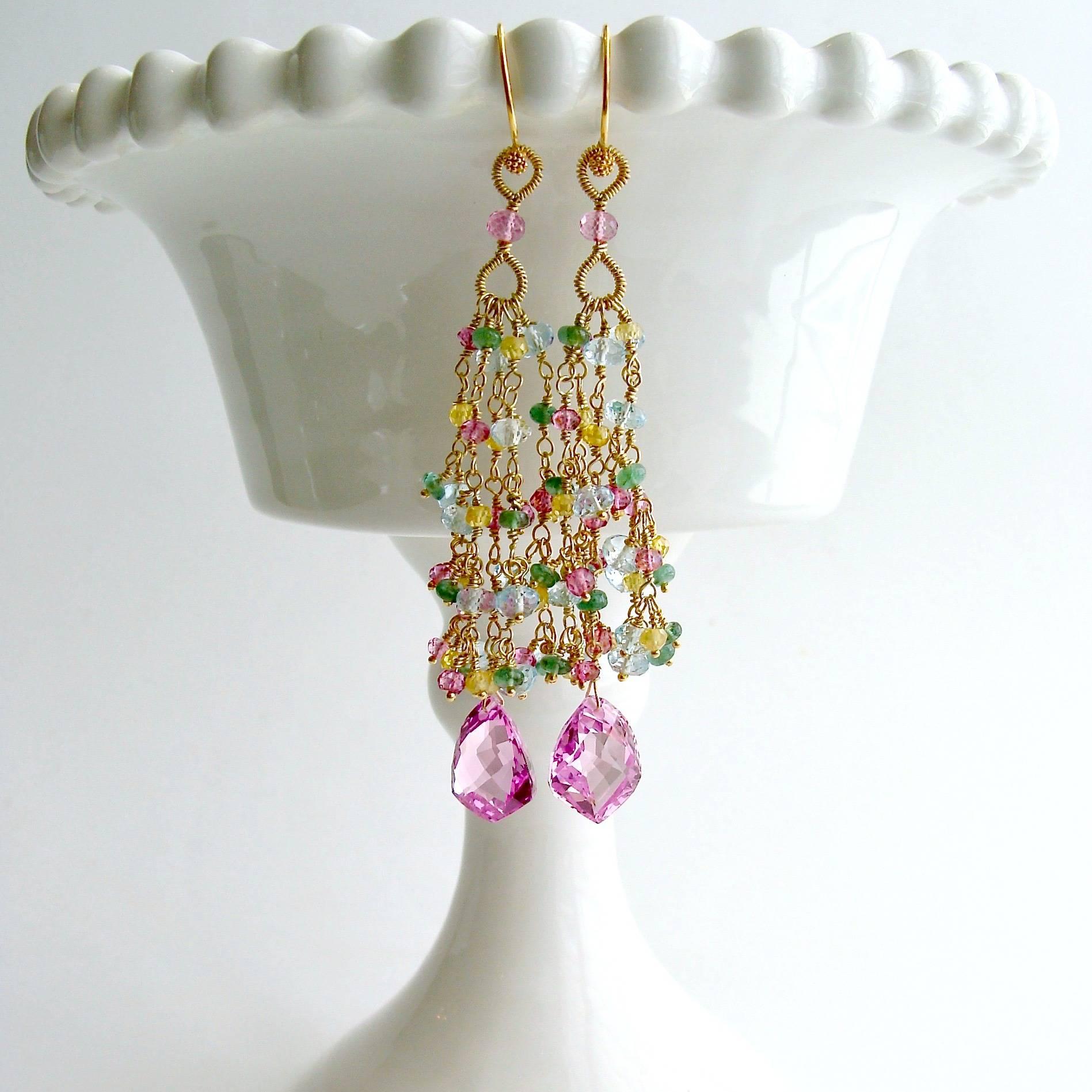 Delphine Tassel Earrings.

Gorgeous shield-shaped pink topaz focal beads are crowned with cascading tendrils of hand linked pink and blue topaz, emerald and yellow zircon rondelles, to create these elongated duster style tassel earrings.  The hand
