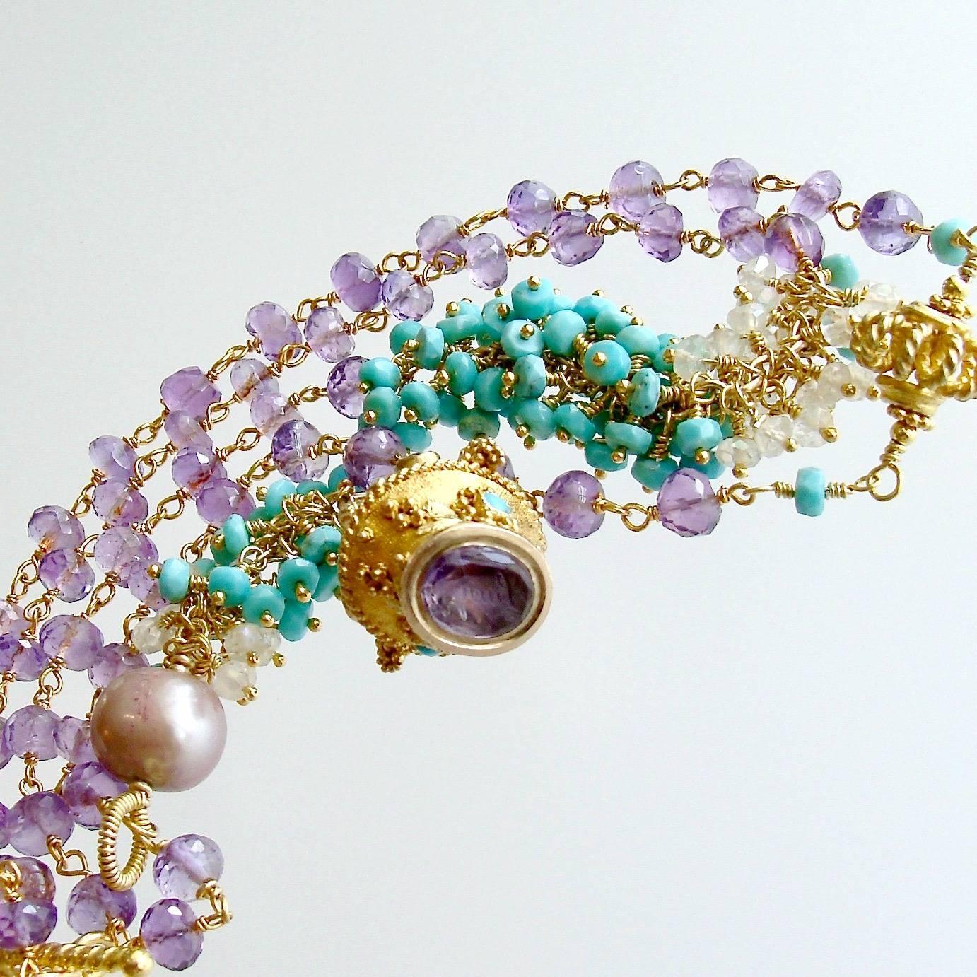 Lucy Necklace.

A delicate strand of hand-linked amethyst rondelles has been asymmetrically intercepted with a frill of Sleeping Beauty Turquoise and mystic moonstone.  A unique openwork gold vermeil bead has been flanked with these same sweet