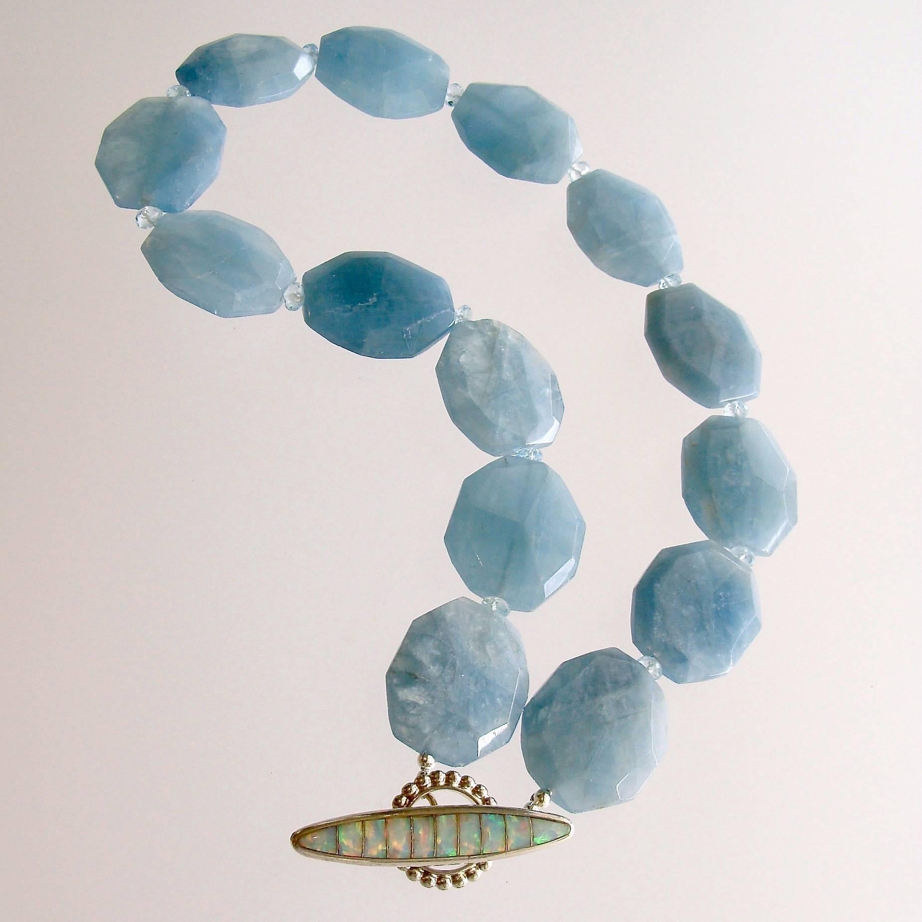 Bree Necklace.

Luxe and luxurious faceted aquamarine slab nuggets are separated with sparkling faceted blue topaz rondelles in this choker necklace design - repeating the rich blue color of the ocean against a white sandy beach.  A gorgeous inlay