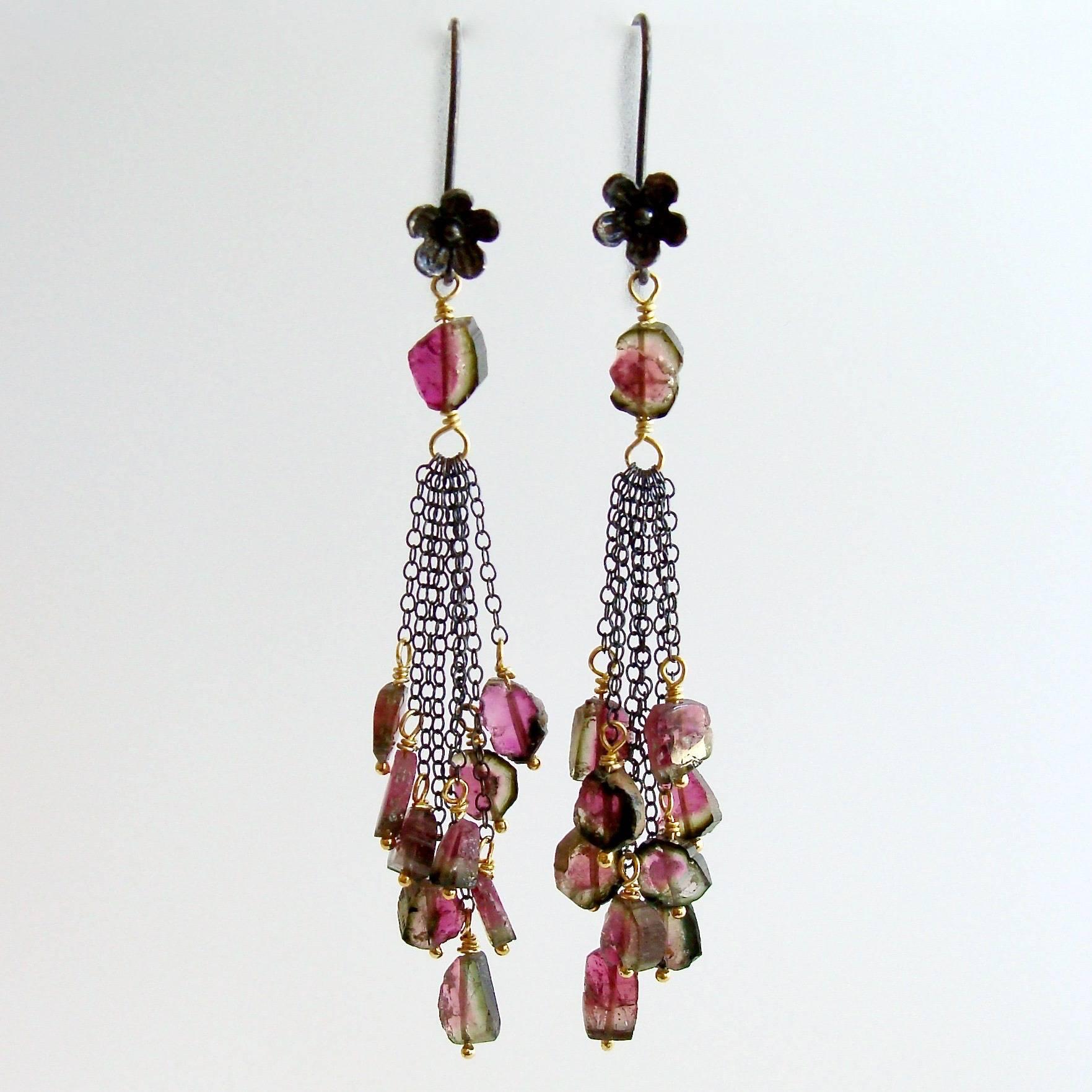 Willow Duster Earrings.

A jaw-dropping grouping of festive watermelon tourmaline slices have been paired with oxidized silver and gold vermeil to create these Bohemian style duster tassel earrings.  The mixed metals of the oxidized silver flower