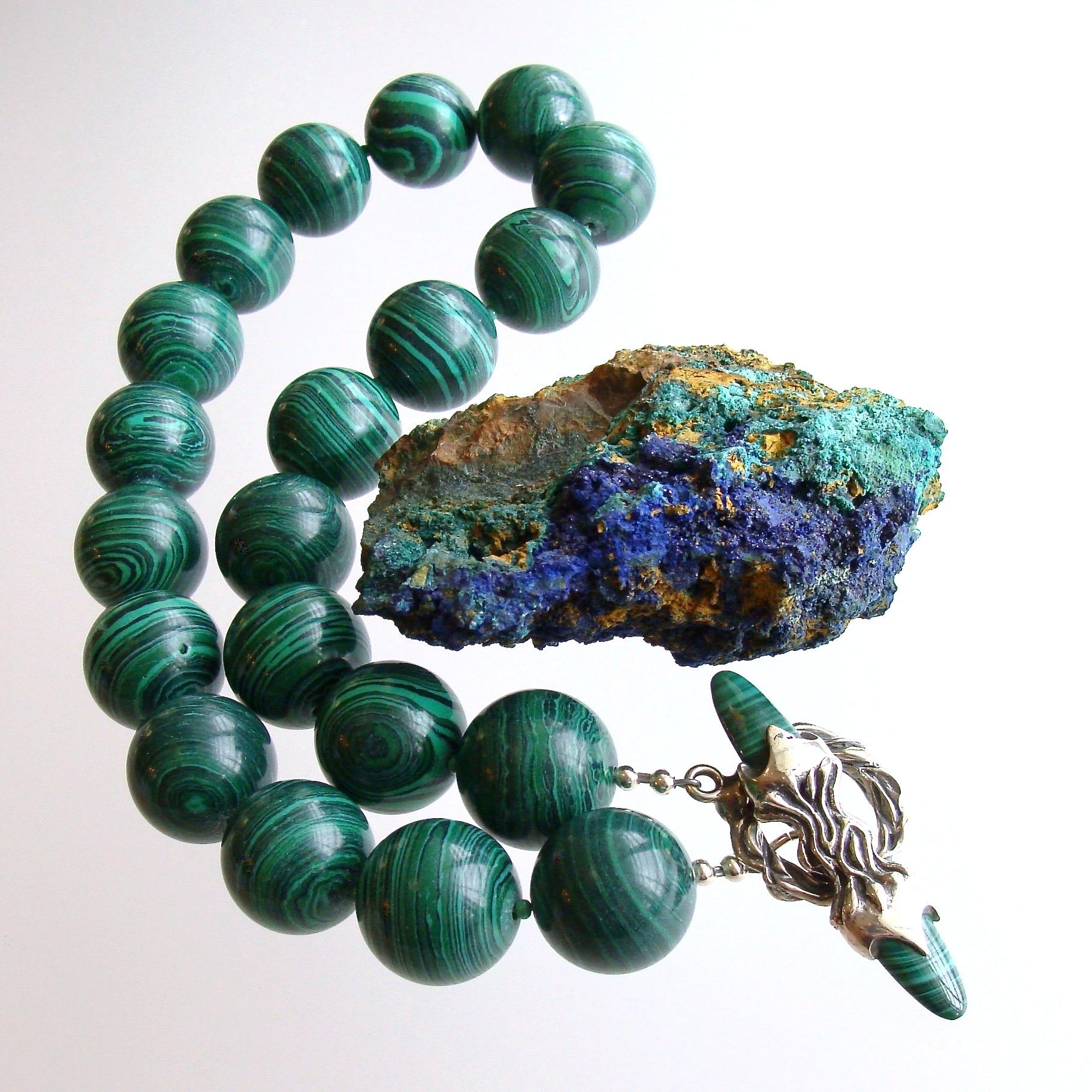 A stunning suite of luxe 19mm malachite beads has been transformed into a dramatic statement choker necklace for Winter.  The swirling black and emerald green colors of the stones are accented with the addition of an organic sterling silver and