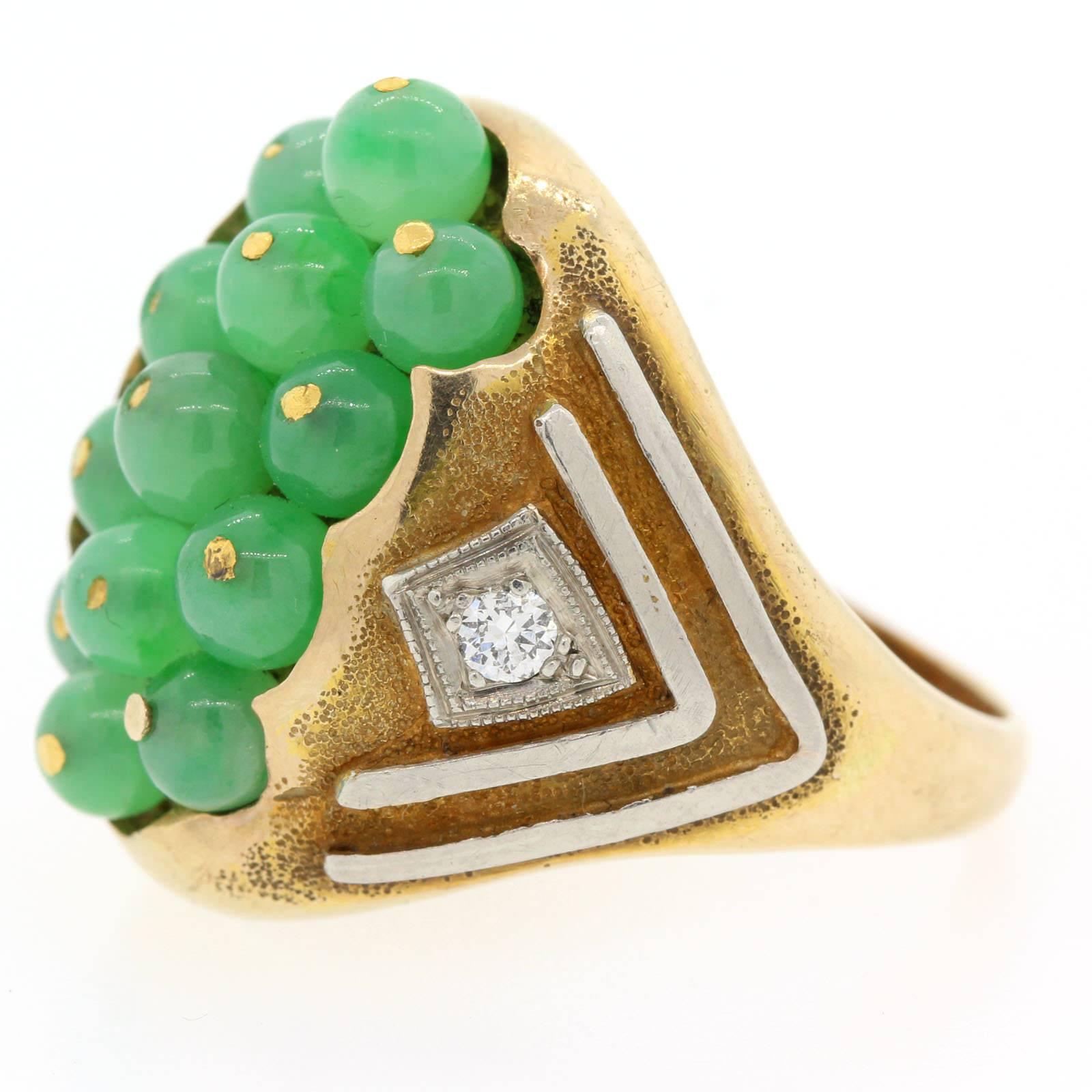 Coveted eclectic ring fabricated in 14KT yellow gold with platinum detalis and featuring a caviar of Jadeite beads.  Two Old European cut diamonds enhance the sides of the ring. One of a kind!