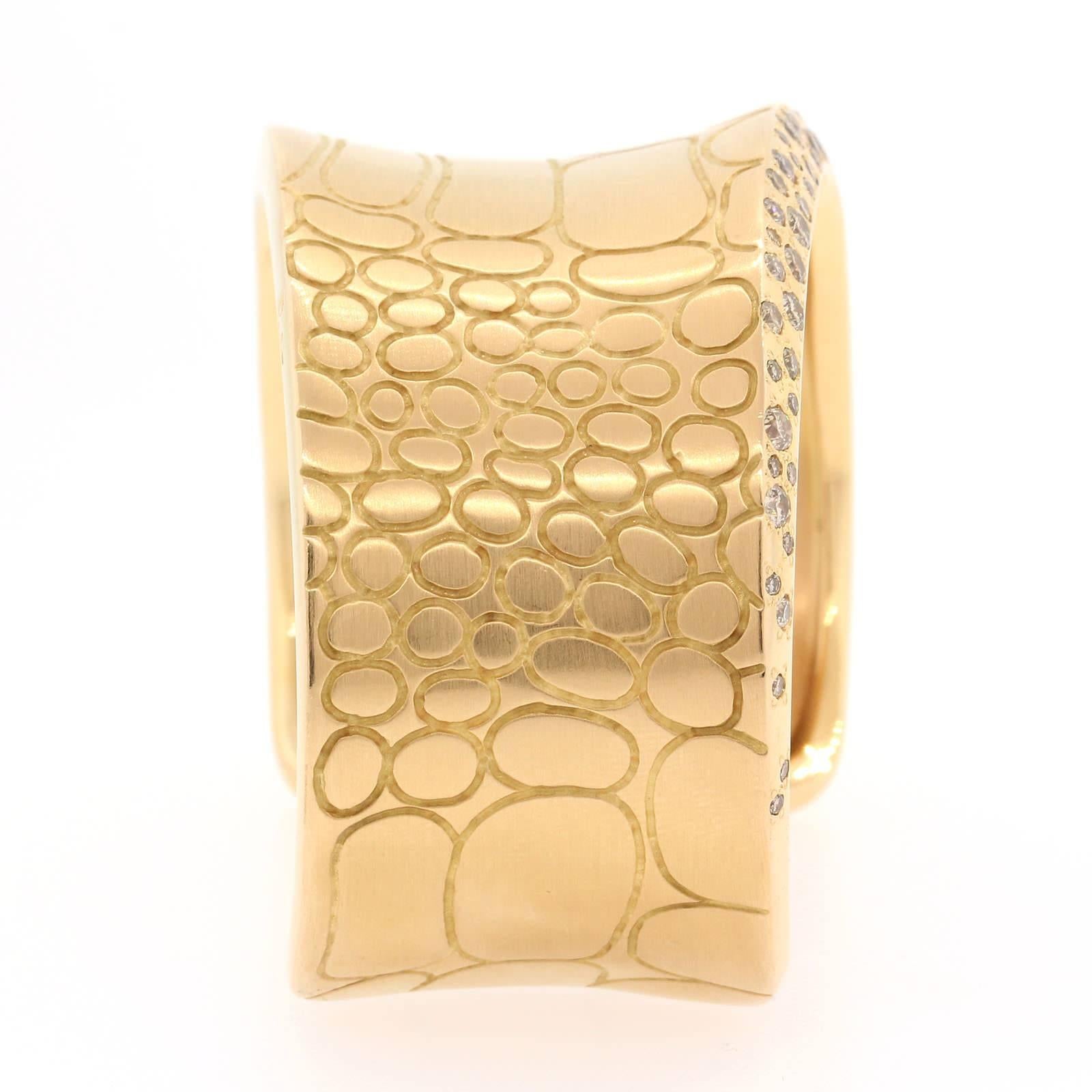 From the Italian house of Pomellato the prêt-à-porter philosophy of every day jewelry represented in this beautifully crafted 18KT yellow gold wide cuff, set with two carats of Round Brilliant Cut Diamonds.  It is quiet a statement!