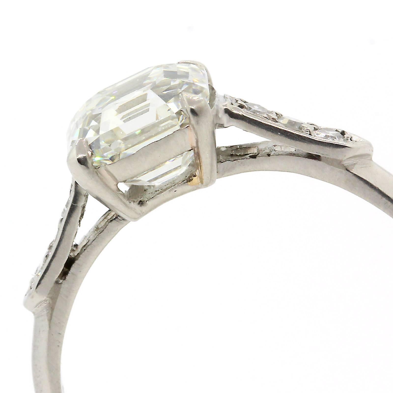The ideal engagement diamond ring!  This 1940s platinum ring features an old  1.53 carats Asscher Cut Diamond, G.I.A. evaluated as J color - VS2 clarity, and accented on each side by old Single Cut Diamonds.   She Will Love It!