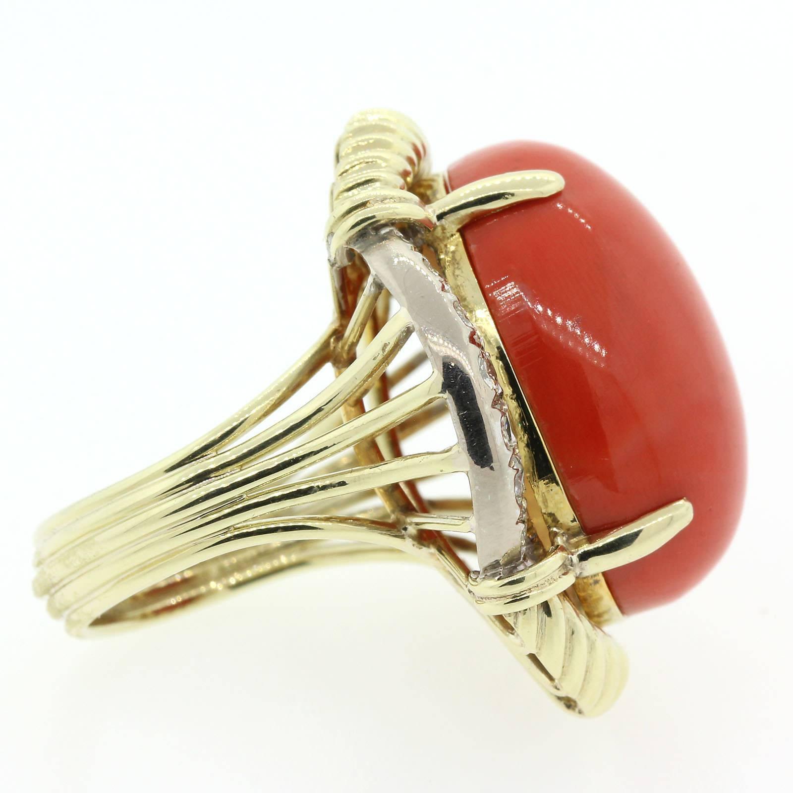 A pristine cabochon cut Coral set in custom made 14KT yellow gold setting.  The ring is accented with a 1.00 carat of Round Brilliant Cut Diamonds of H color - VS clarity.  