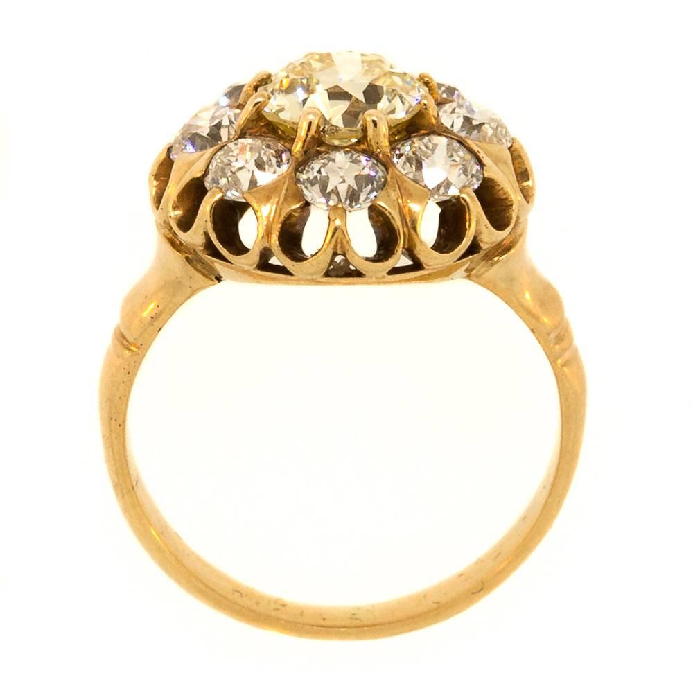 Coveted and beautiful 1910 14KT yellow cluster ring featuring a certified Light Yellow color Old European Cut Diamond, surrounded by 2.00 carats of Old European Cut Diamonds. The setting is of a crown design of an open gallery. It  is absolutely