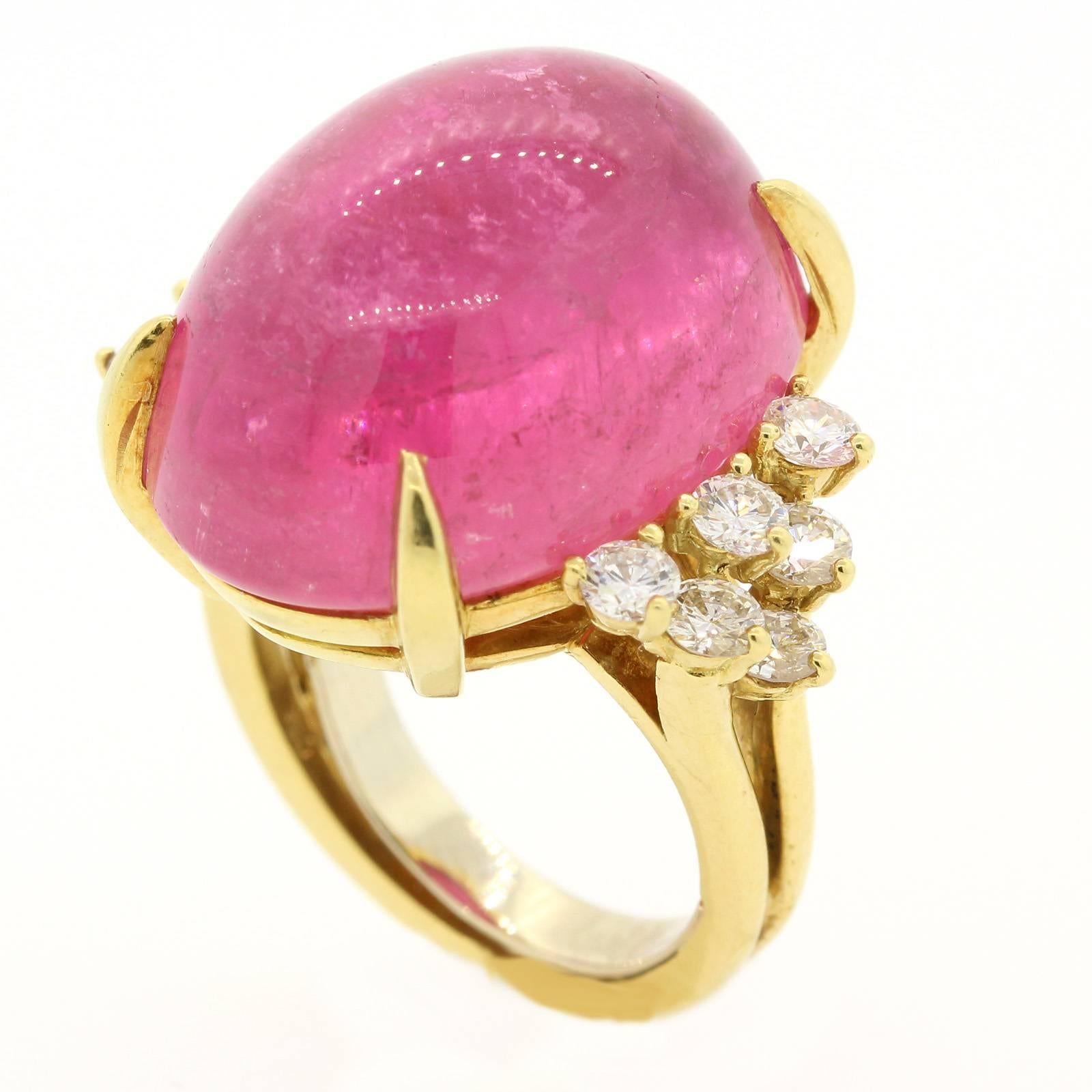 A Happy and Bright Cocktail Ring!  The 18KT yellow gold setting features a beautiful cabochon cut, 3.30 carats Pink Tourmaline, flanked by twelve Round Brilliant cut Diamonds weighing 0.75 carat.  The diamonds are of G/H color - VS clarity.  It is