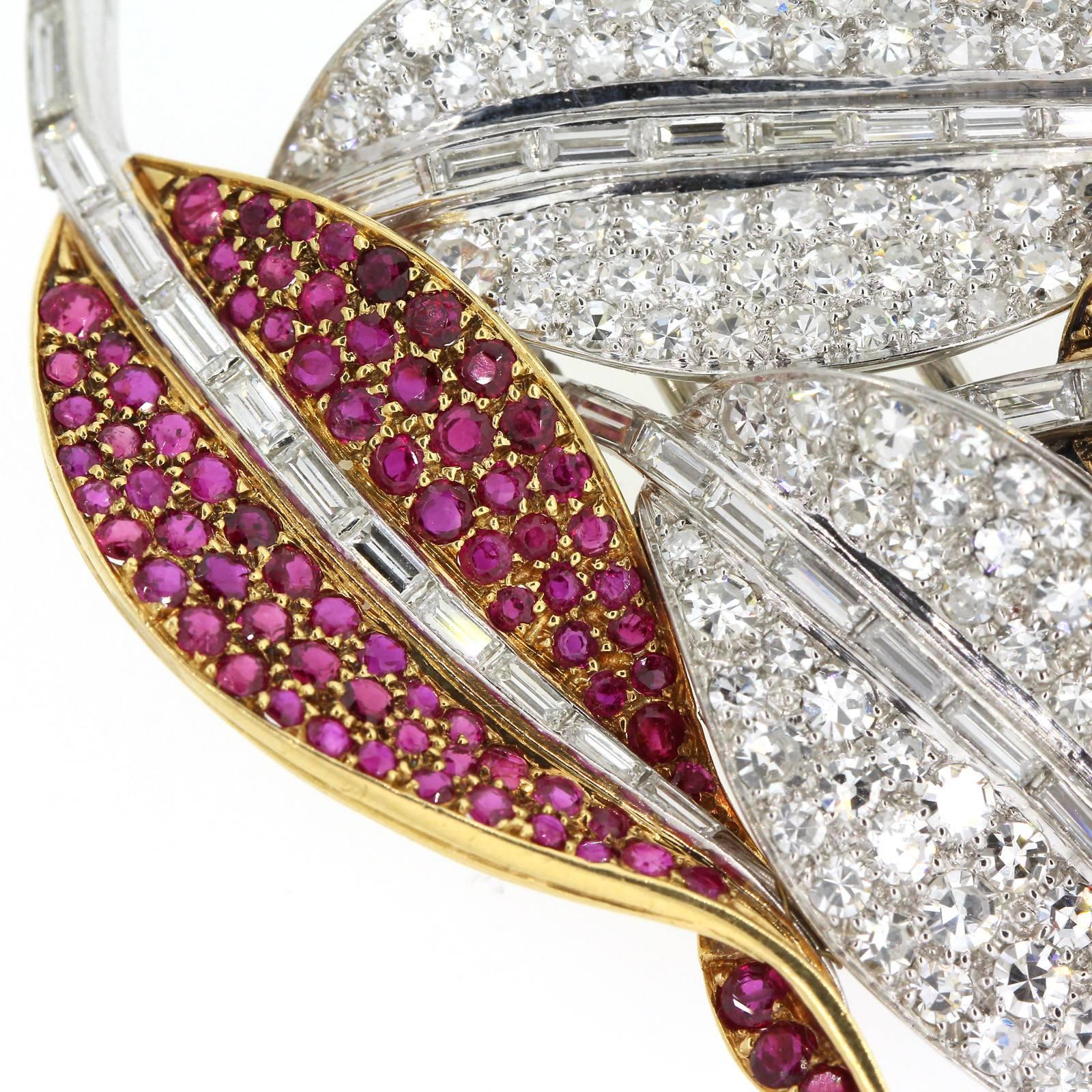 Elegantly brilliant Diamond and Ruby platinum leaf brooch/clips.  Nine carats of of Round Brilliant and Baguette cut diamonds fire up this beautiful piece. Two leaves are set with over three carats of red round cut Rubies and are accented with a