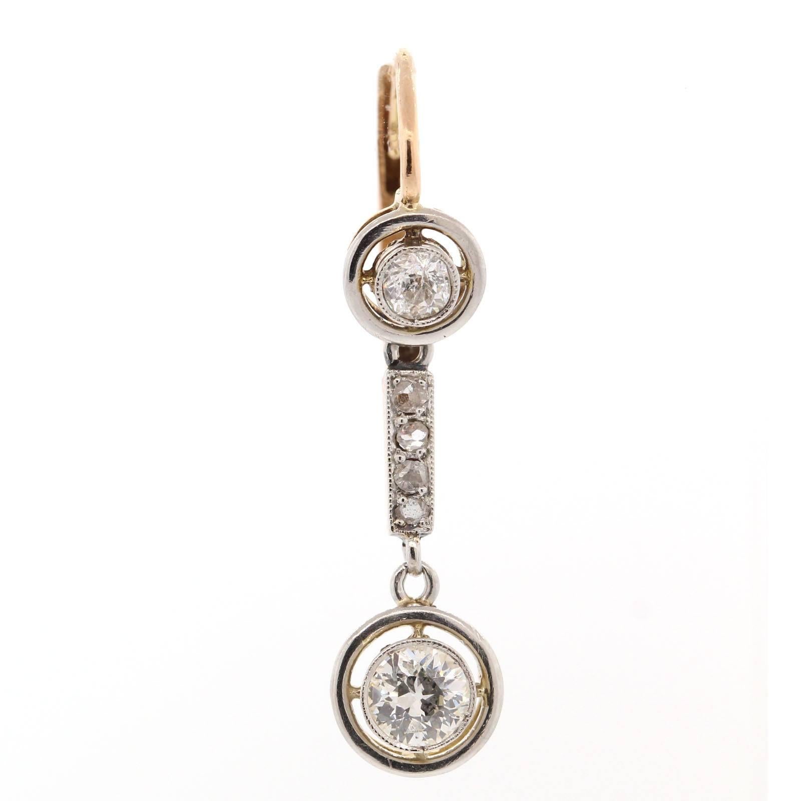 Delicately elegant these dangling 1930s platinum and 18KT diamond earrings, set with Old European Cut and Rose Cut Diamonds.  A forever gift!