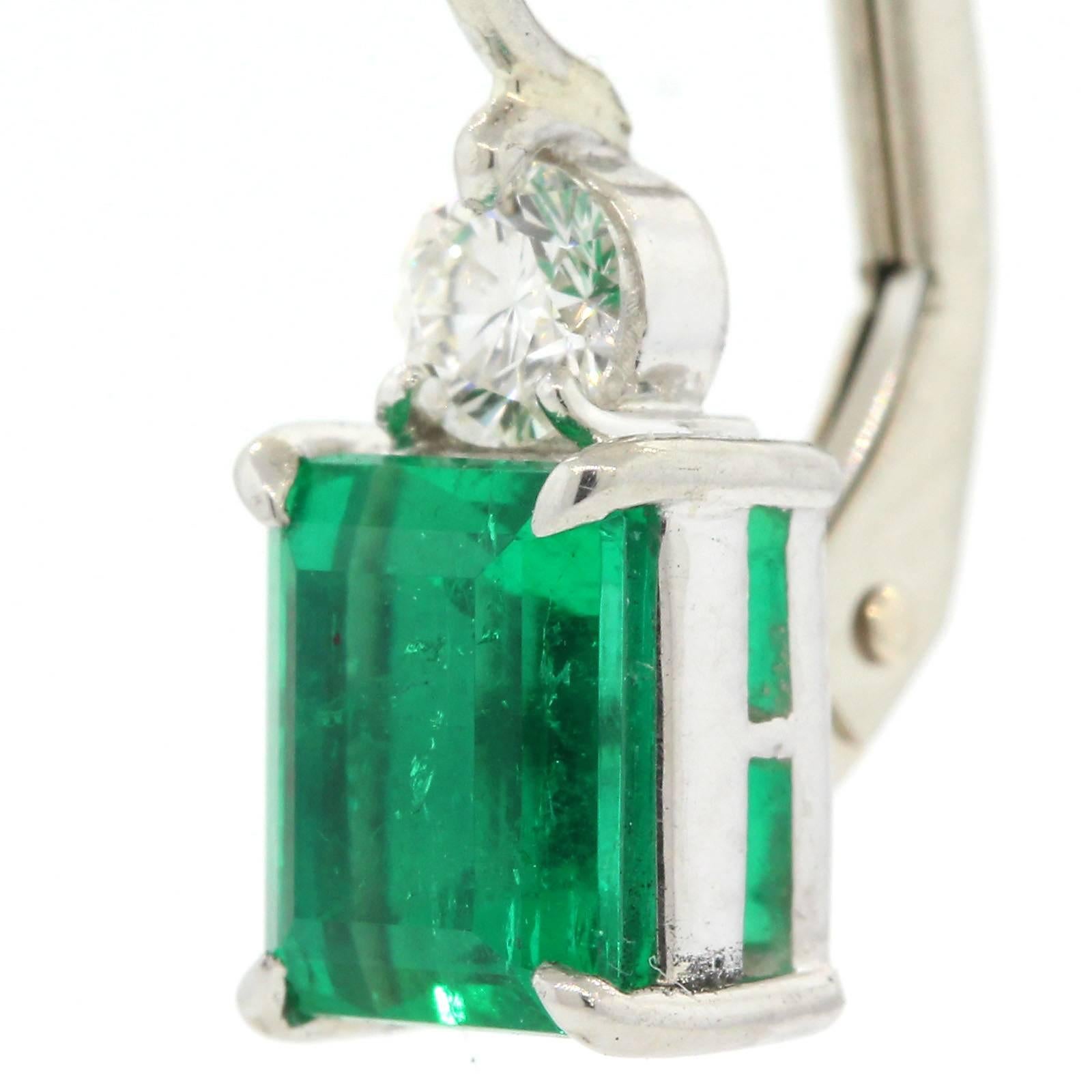 Simply Beautiful! Bright green Colombian emerald cut Emeralds weighing 1.67 carats set on platinum and accented with two Round Brilliant cut Diamonds of H/I color - VS clarity.  Perfect for everyday wear!