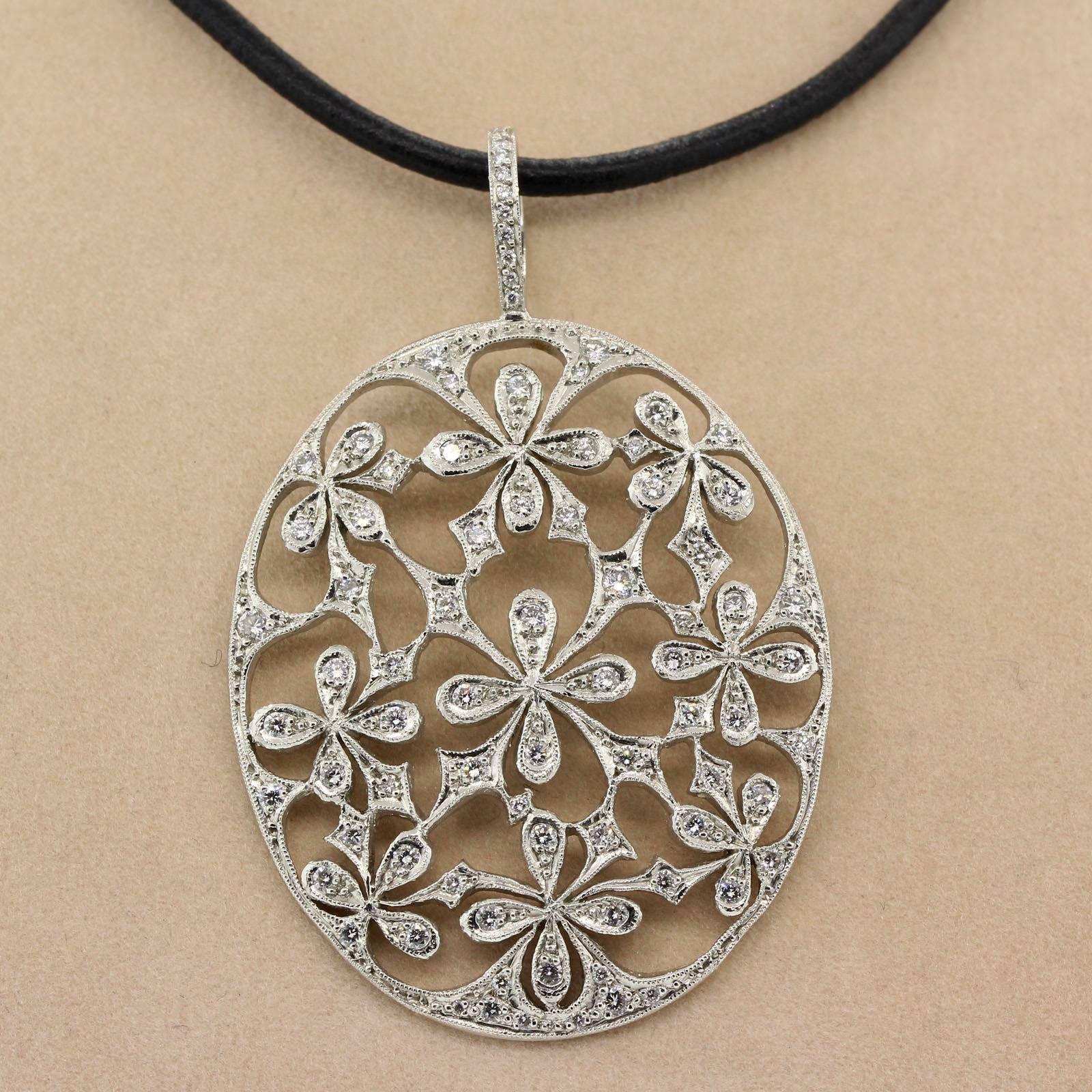 Lovely! Cathy Waterman's  open work daisy design diamond pendant set with one carat five of sparkly Round Brilliant Cut Diamonds.  Pendant dangles from original leather cord. 