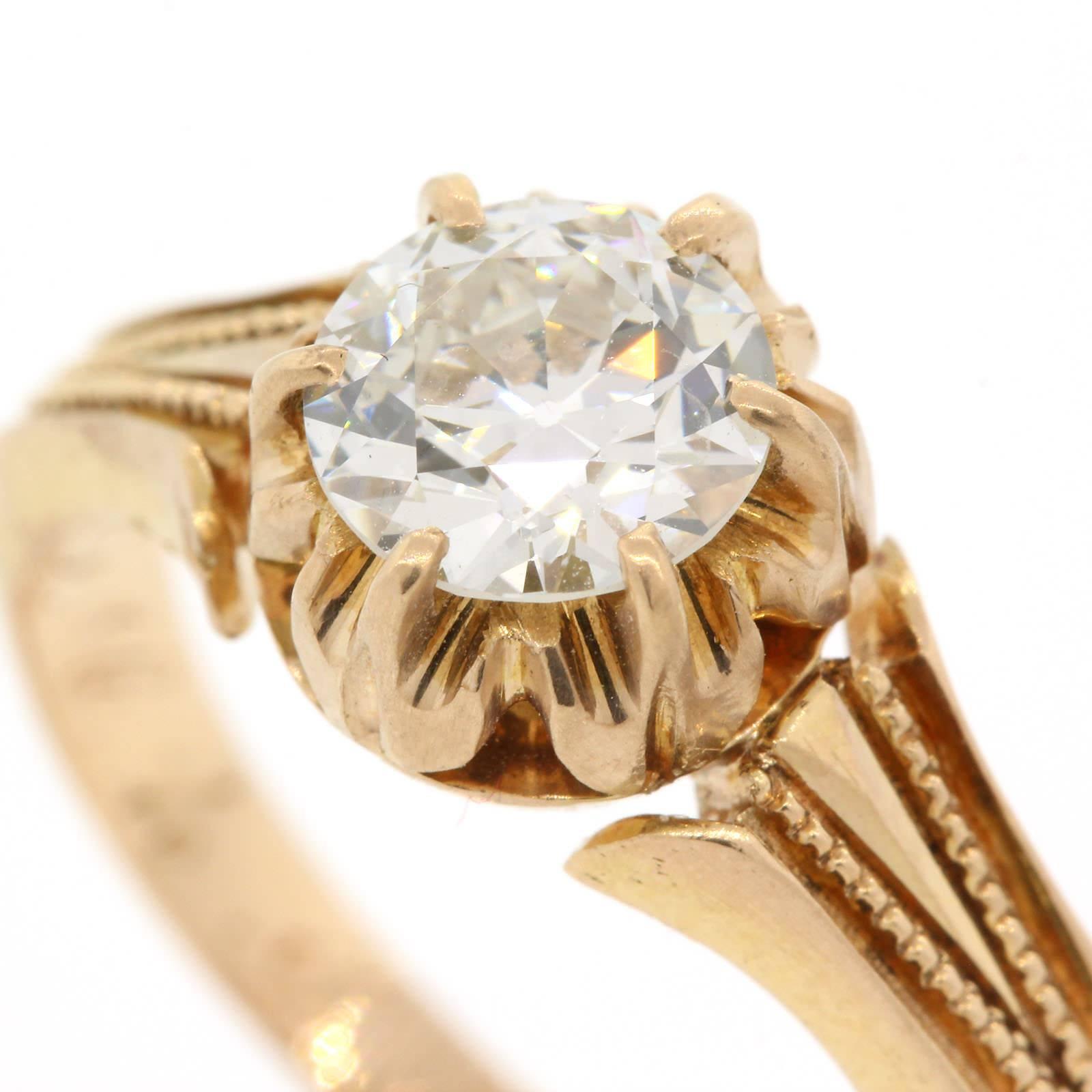 A gorgeous Victorian 14KT yellow ring set with 0.94 carat Old European Cut Diamond, certified F color - VS2 clarity.  The six prong setting is accentuated with beautifully coveted milgrain.  Circa 1890s.