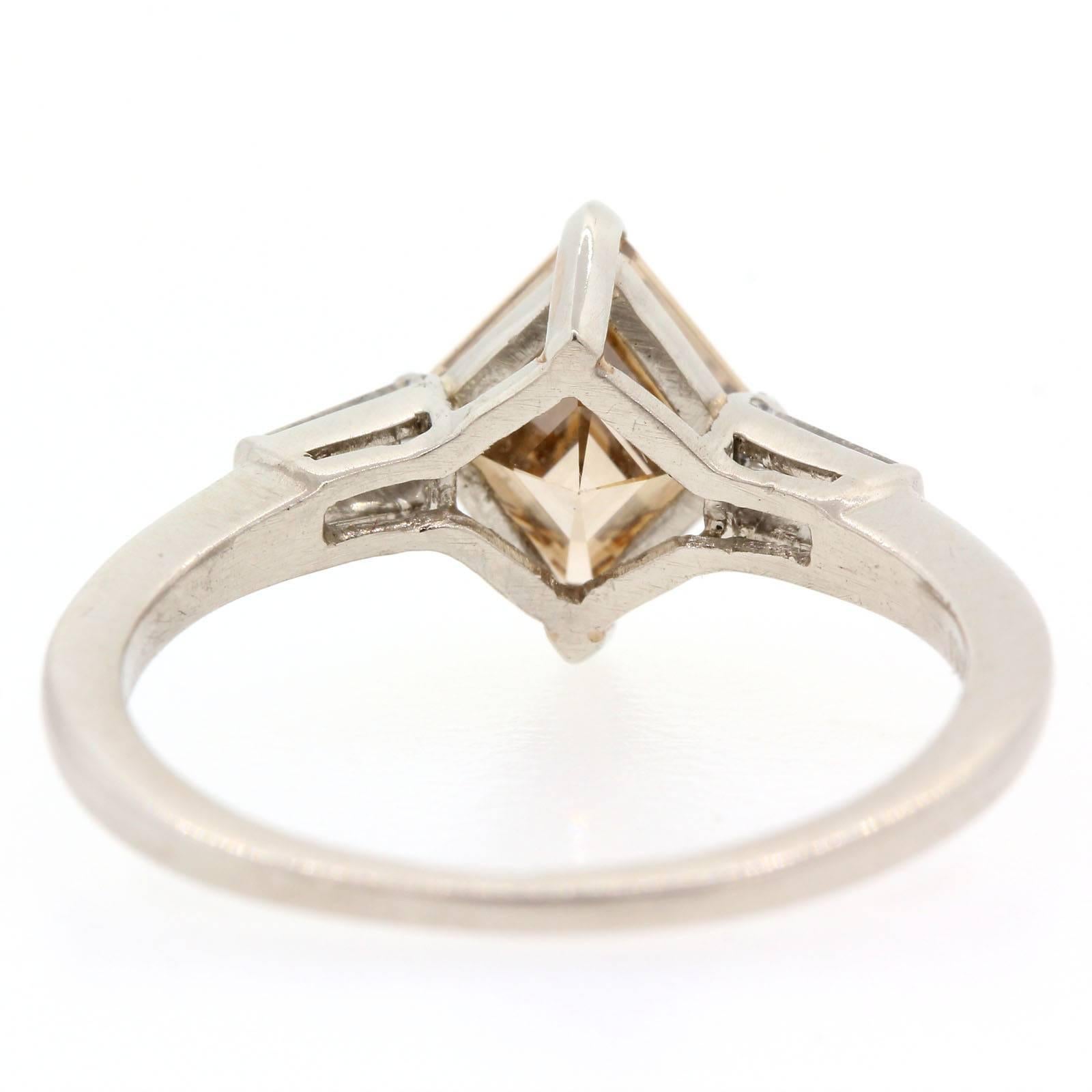 Unique 1940s diamond shape Cut Diamond certified E.G.L. Fancy Brown - VVS2 clarity.  The platinum setting is accented with two Baguette Cut Diamonds of H/I color - VS clarity.  The vintage ring is ring size 6.  An Enviable Ring!