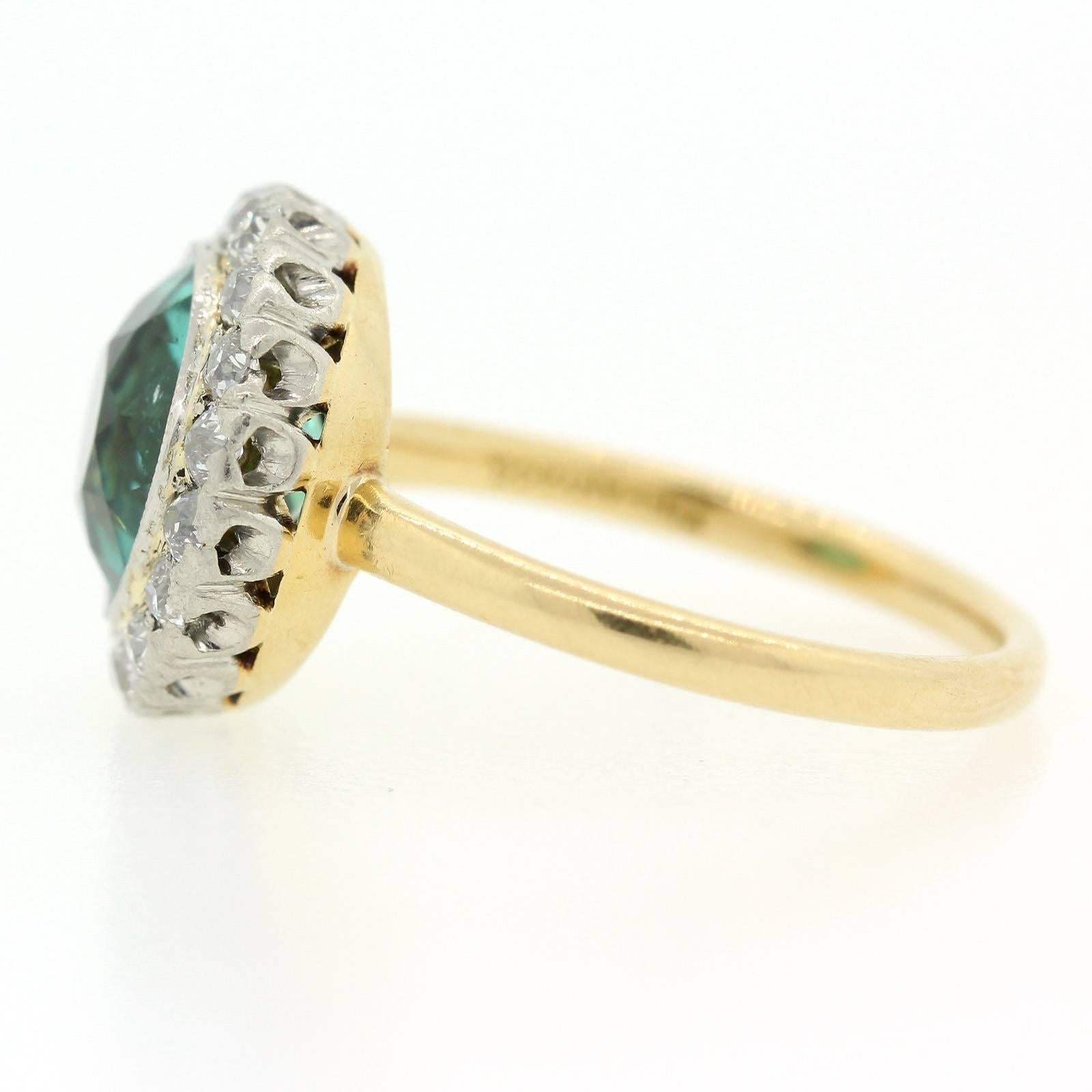 A beauty from the past this coveted Edwardian Tiffany and Co. platinum and 18KT yellow gold ring featuring a gorgeous A.G.L. certified Blue-Green round cut Tourmaline weighing approx. 3.20 carats.  The setting is accented with a one carat ten Old