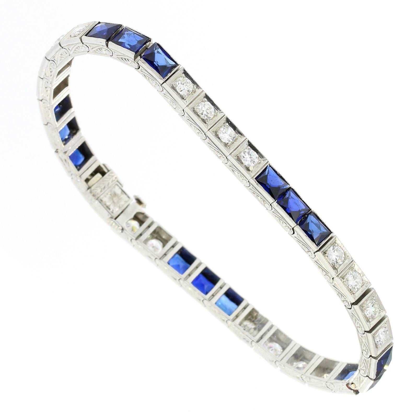 An original and pristine box link design straight line.  The bracelet is fabricated in platinum and set with two carat of Old European Cut Diamonds alternating with five sections of French Cut original Synthetic Sapphires.  Elaborate hand engraving