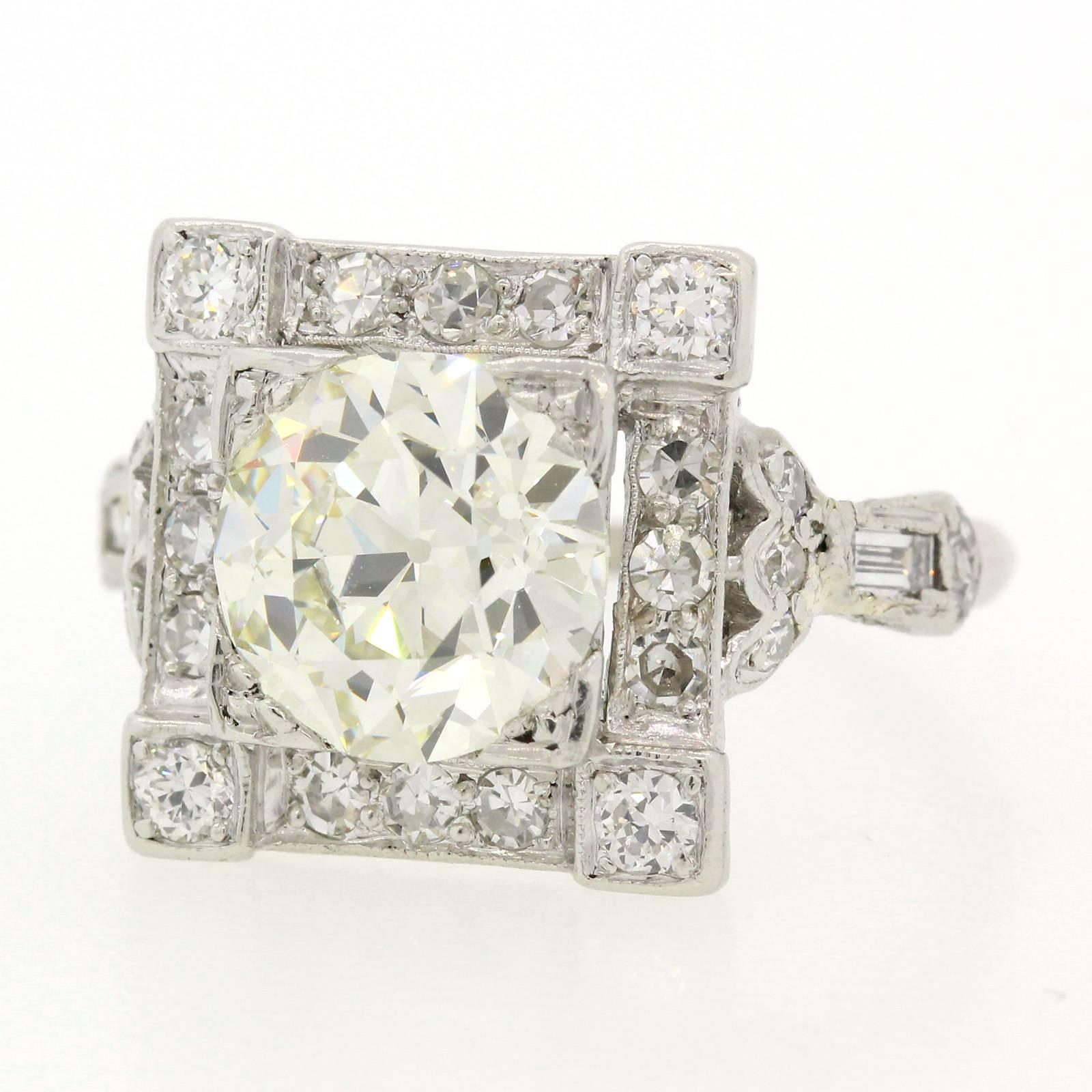 Splendorous Art Deco ring featuring a 2.40 carat Old European Cut Diamond, certified E.G.L. USA N color - VVS2 clarity.  The diamond is set in a square platinum setting accented by four Old European Cut and twelve old Single Cut Diamonds.  The sides