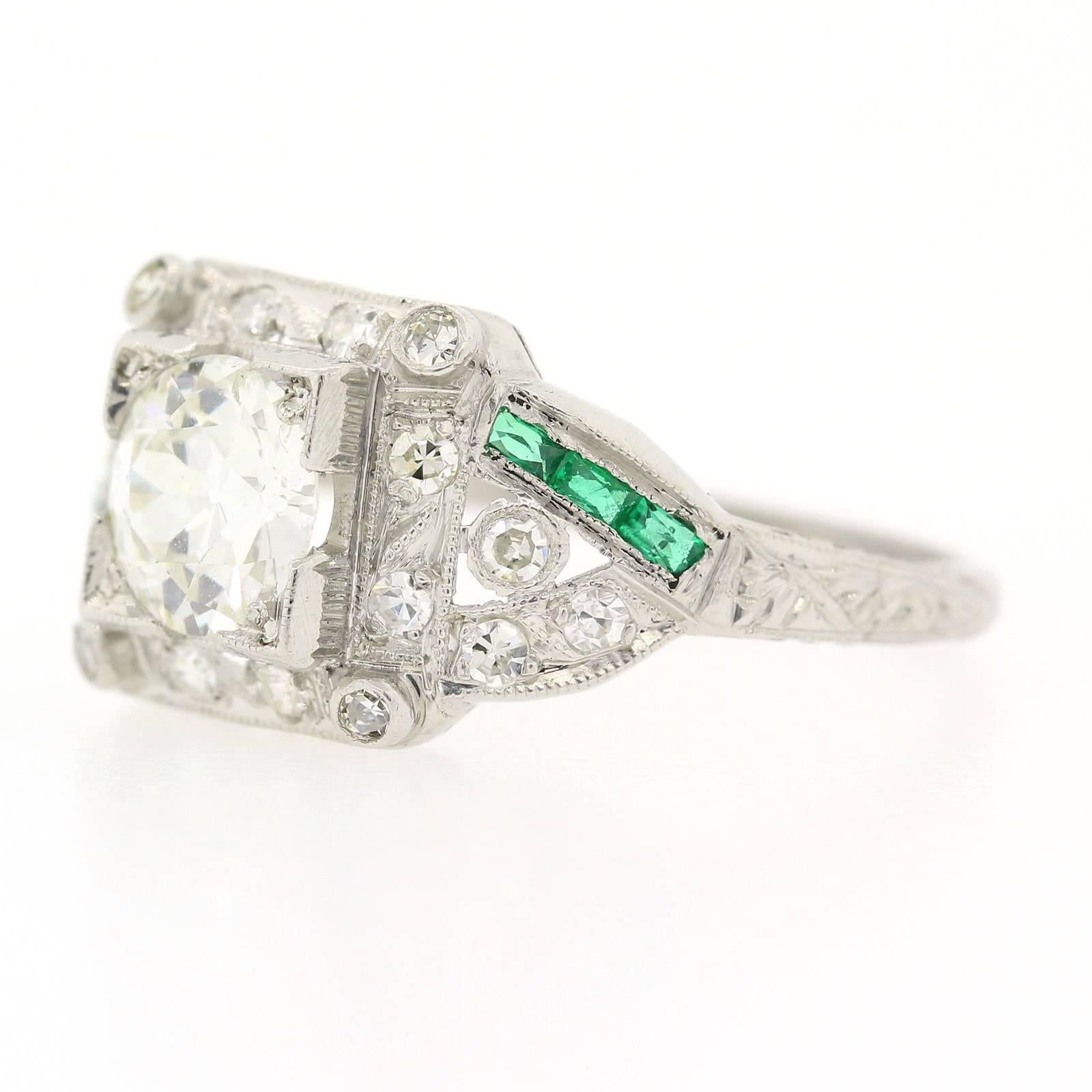 An pristine Art Deco Diamond, Emerald platinum ring featuring an 0.83 carat Old European Cut Diamond of I color - VS2 clarity.  The ring is accented with six calibrated Baguette Cut Emeralds and eighteen Single Cut Diamonds, and enhanced with time