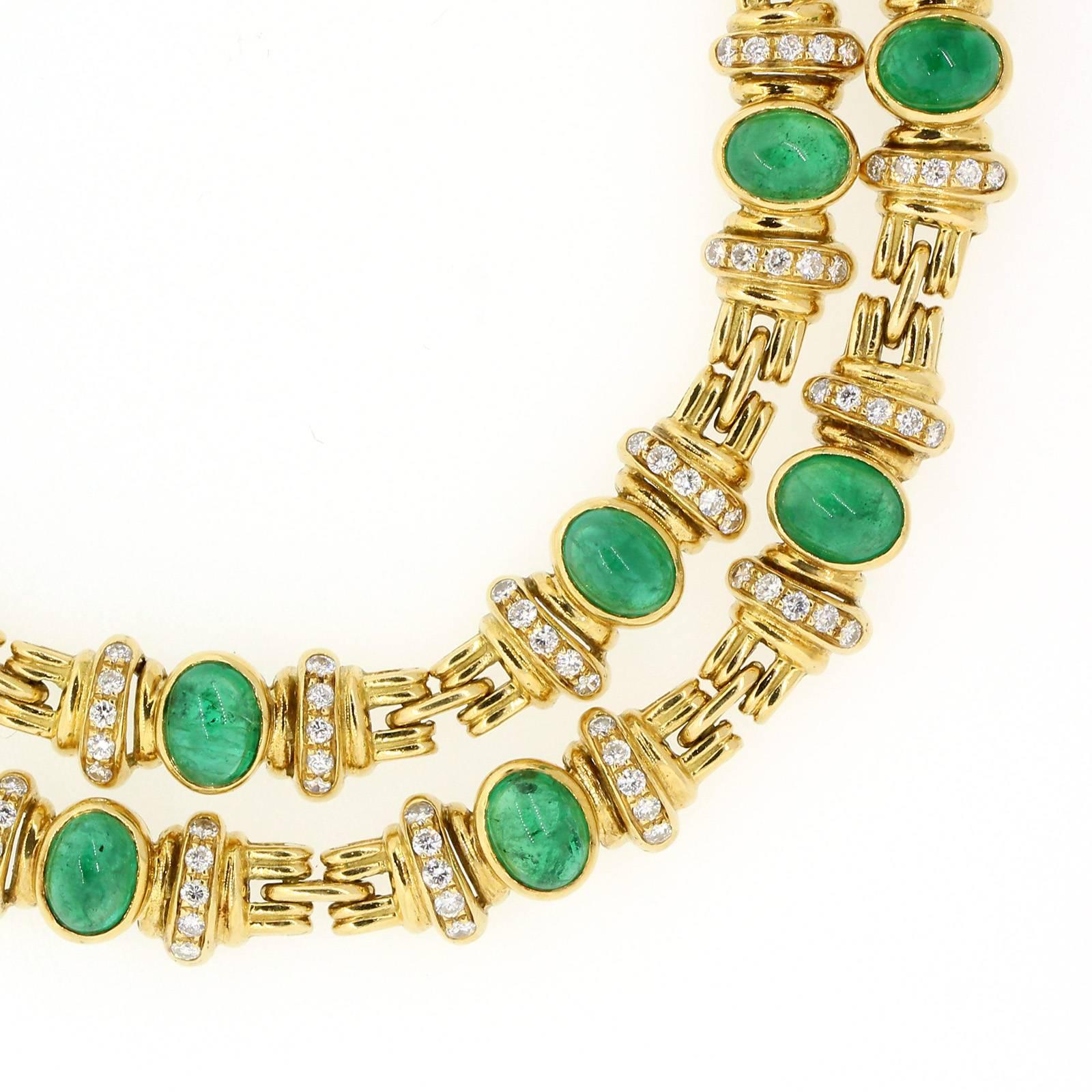This stylish 18KT yellow gold double strand necklace features seven cabochon cut Colombian Emeralds.  The necklace is designed  with  twenty four half roundels, fourteen of which are accented with a total of 2.10 carats of Round Brilliant Cut