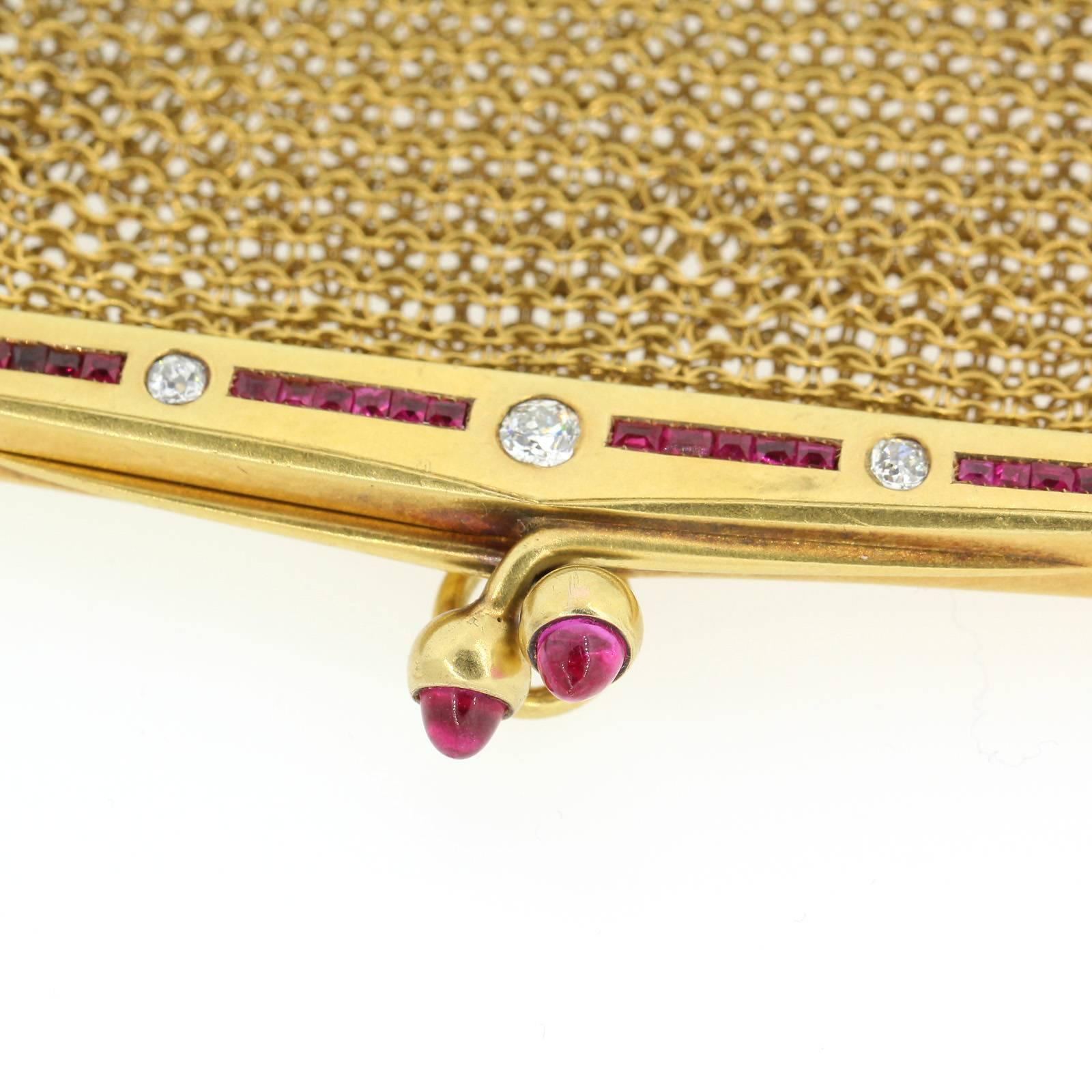 An exquisite English 18KT yellow mesh coin purse from circa 1900.  The frame is accented with a line of five Old European Cut Diamonds and calibrated synthetic Rubies.  The pendant purse is suspended from a vintage 14KT yellow gold, thirty two inch