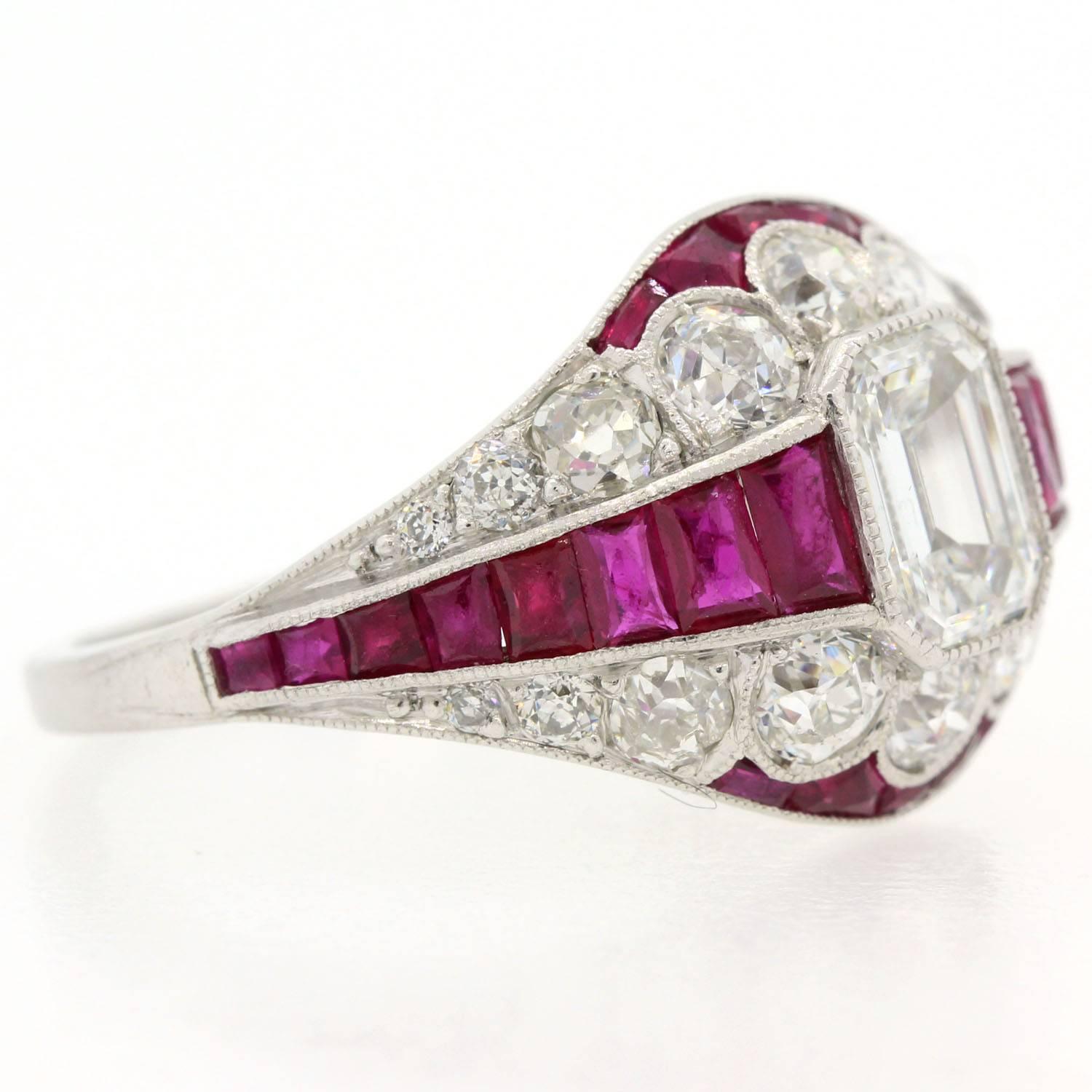 A brilliant Art Deco revival platinum ring set with Diamonds and Rubies.  This dome-like ring features an Emerald Cut Diamond weighing 0.81 carat of H/I color - VS2 clarity flanked with sixteen graduated French Cut Burma Rubies.  The setting is 