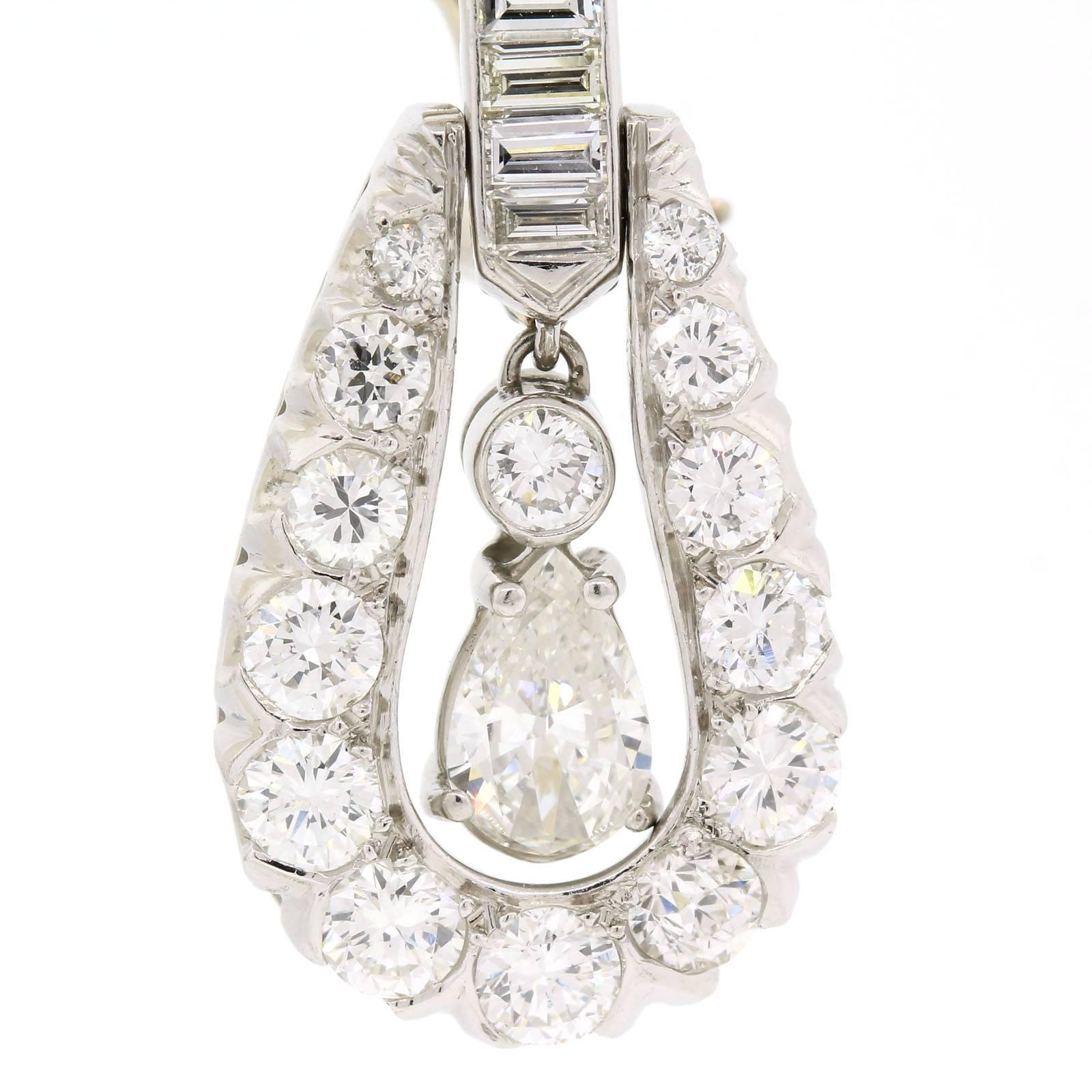 Brilliant 1960s platinum articulated diamond earrings, featuring a dangling Pear shape Diamond.  The stylized 