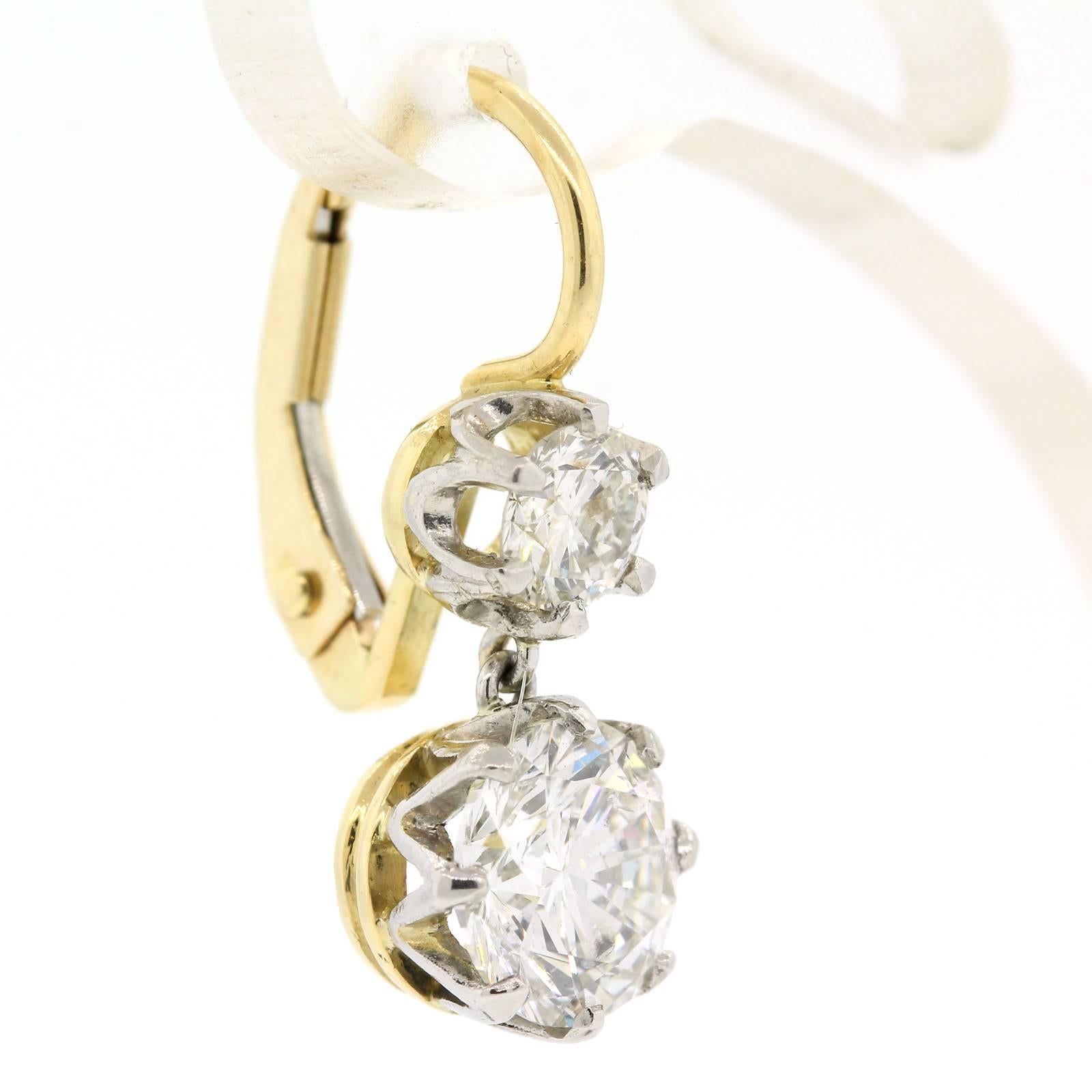 Gorgeous Round Brilliant Cut Diamond earrings fabricated in platinum and 18KT yellow gold.  They feature two smaller top diamonds, 0.25 carat each;  and two larger bottom diamonds, one a 1.03 carat and the other a 1.00 carat.  The total diamond