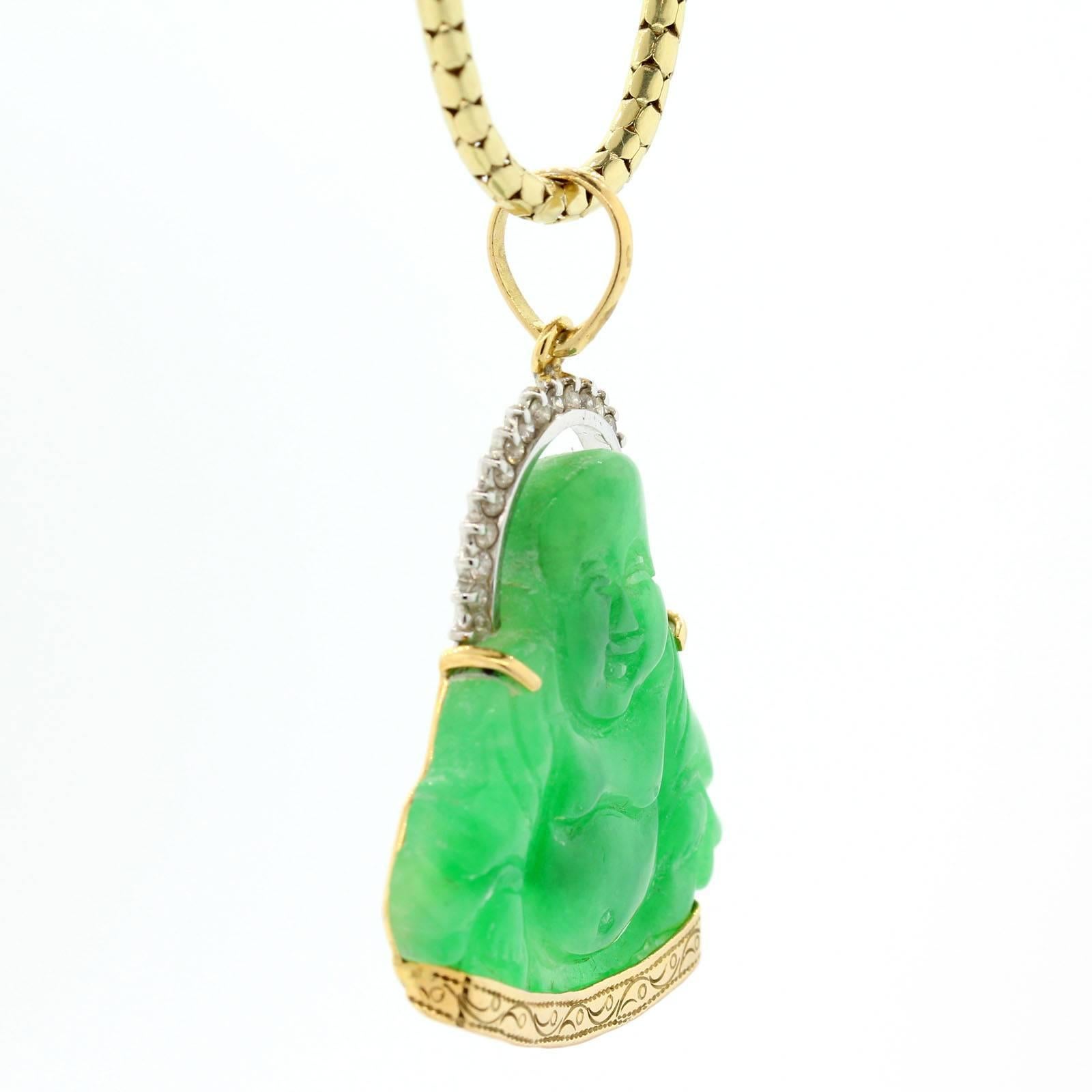  An uplifting, feel good 18K carved Jadeite Buddha figure resting on an engraved gold frame.  The Buddah is accented with a  sparkly halo of 0.40 carat of Round Brilliant Cut Diamonds.   The pendant is suspended from an 18" long 14KT yellow