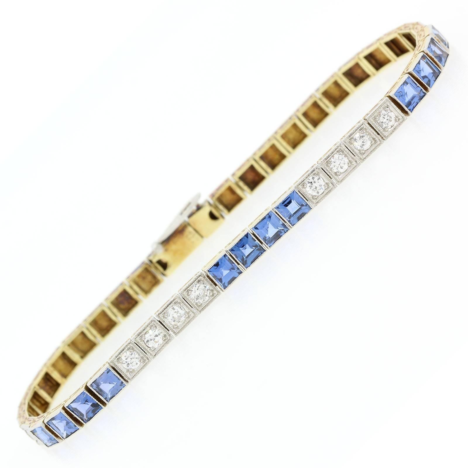 A beautiful 1920s straight line platinum topped 14KT yellow gold bracelet.  The bracelet has three sections of square cut Montana Sapphires alternating with two sections of four European Cut Diamonds.  The Sapphires weigh a total of approx. 3.10