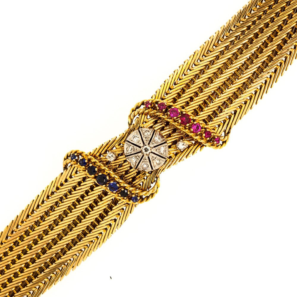 French 18 KT Yellow Gold Mesh Bracelet features a White Gold Disk set with nine Single Cut Diamonds. Accented by two bonus diamonds, this piece is hypnotic and full of surprises. Chic and beautiful, the bracelet is adorned with two swirl designs.