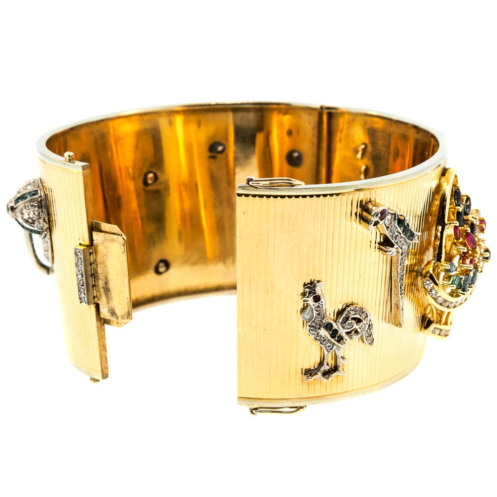 Applique Charm Cuff is a work of art, made from 14 KT Yellow Gold. Upon the wrist, the cuff stands out among the rest as a result of nine glistening charms. Dating back to the 1950s, this fits in with any vintage collection. Creatively placed, among