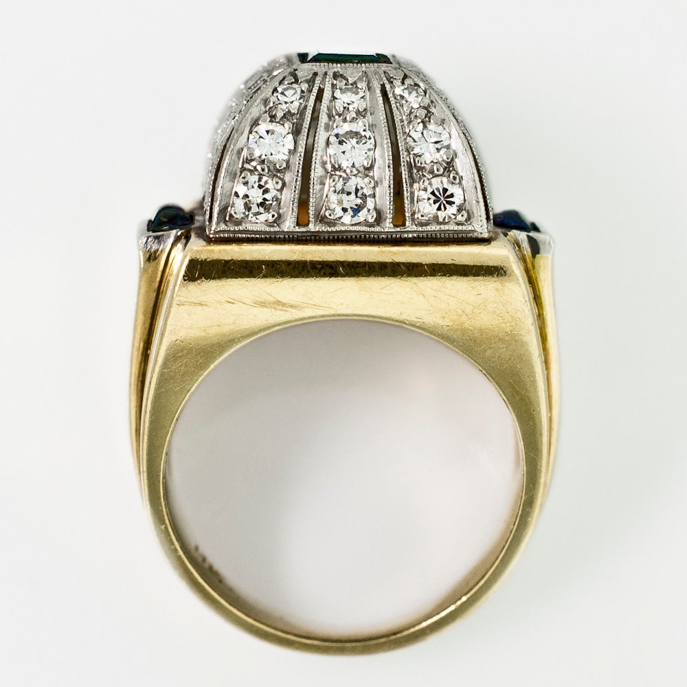 Retro Dome Design Platinum 14 KT Yellow Gold Ring showcases a rectangular cut Sapphire. Surrounding the central gem are Transitional and Single Cut Diamonds. A bold and enlivened piece, there is a surprise around every corner. Two small cabochon cut