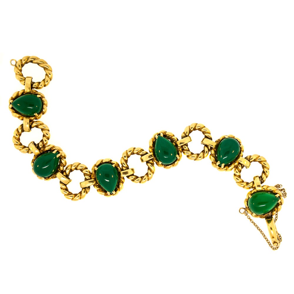 Vintage Tiffany & Co. Bracelet is composed of six pear-shape Cabochon Chrysophrase Quartz and twisted oval shape 18 KT Gold Links. A classic piece, the last link includes a plaque stamped with the iconic Tiffany & Co. logo. Dating back to the 1960s,