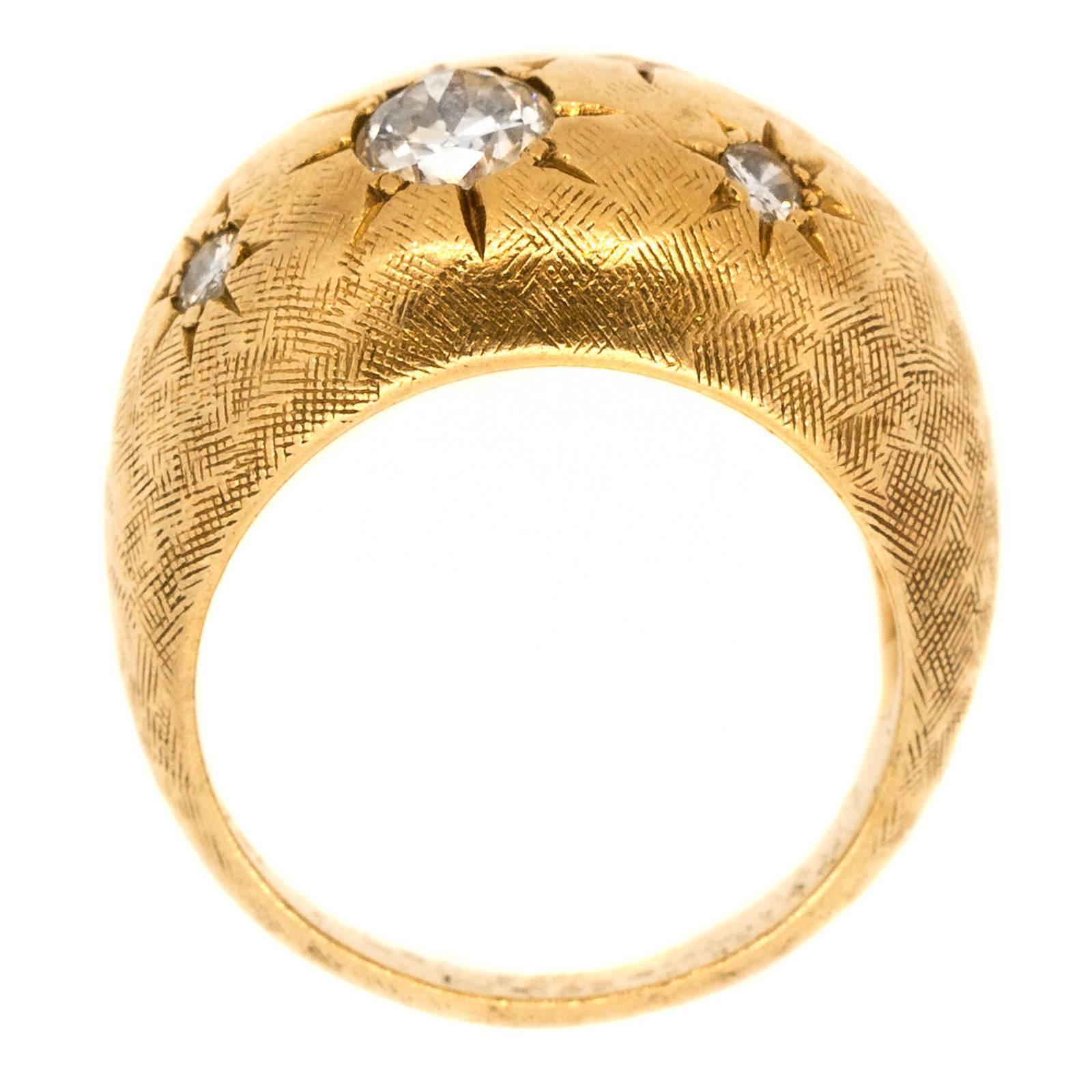 The dome design ring is fabricated in 14KT yellow gold and is set with two Old European Cut Diamonds and three Round Brilliant Cut Diamonds.  All five diamonds are of H/I color -VS/SI clarity.  The ring is enhanced with a time worn Florentine