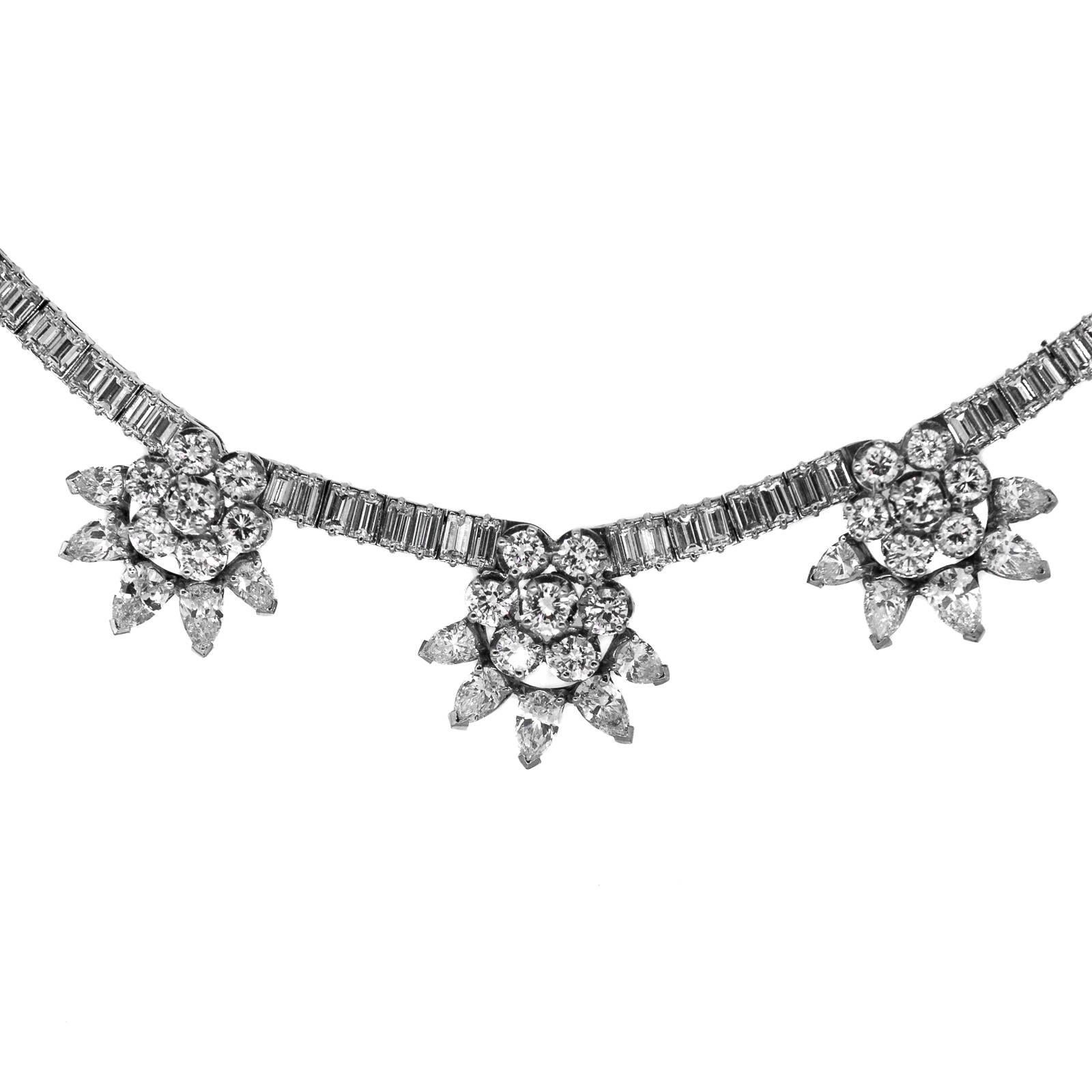 This beautiful platinum necklace has five dangling stars of Pear & Round Brilliant Cut Diamonds at its bottom, spaced between forty four Marquise Cut Diamonds. It is completed with fifty eight Round Brilliant Cuts and accented with twelve Marquise