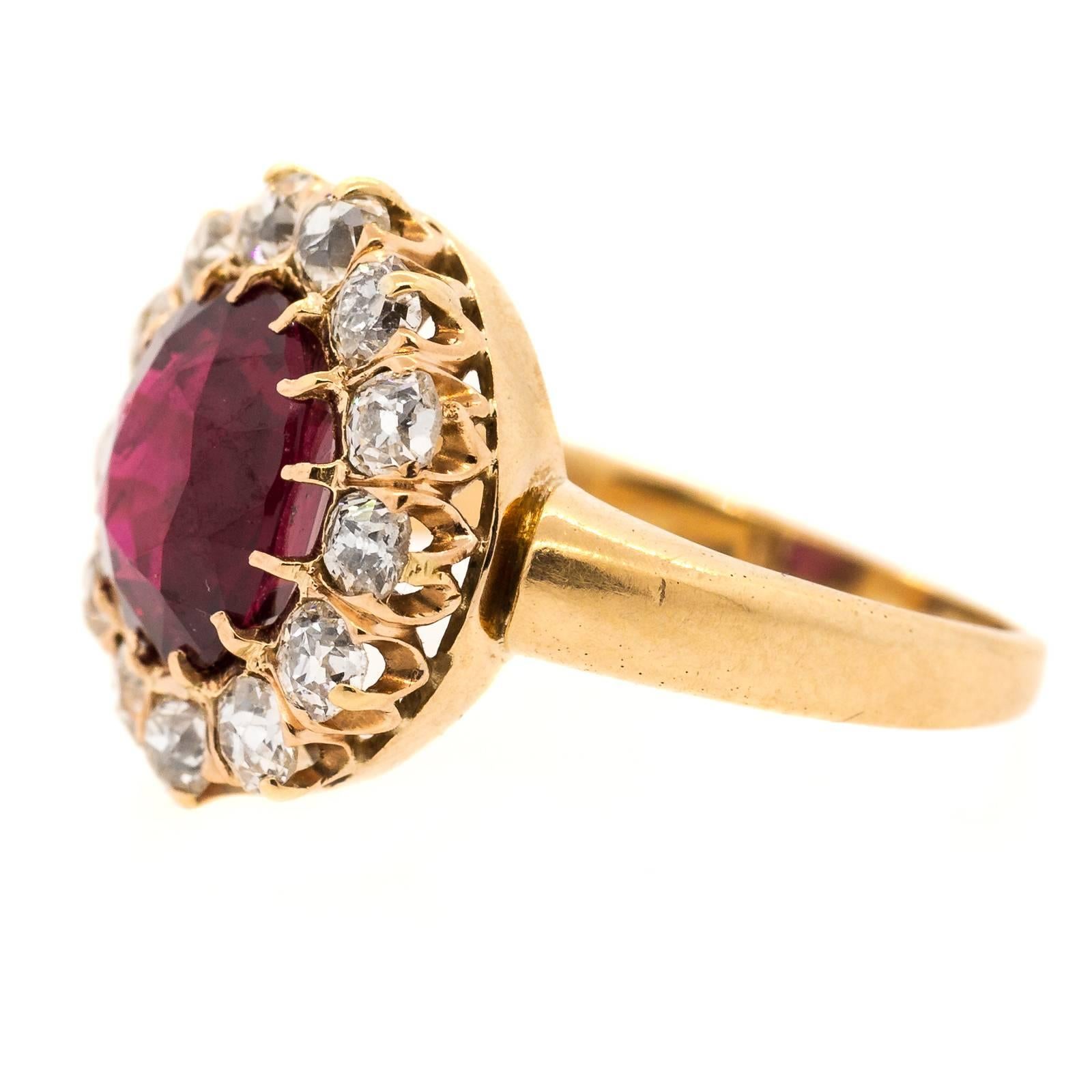 Splendorous circa 1910 three twenty-five carats G.I.A. Thai Ruby set in a fabulous 14KT yellow gold cluster setting and surrounded by thirteen Old European Cut Diamonds of H/I color.  A brilliant piece from the past!