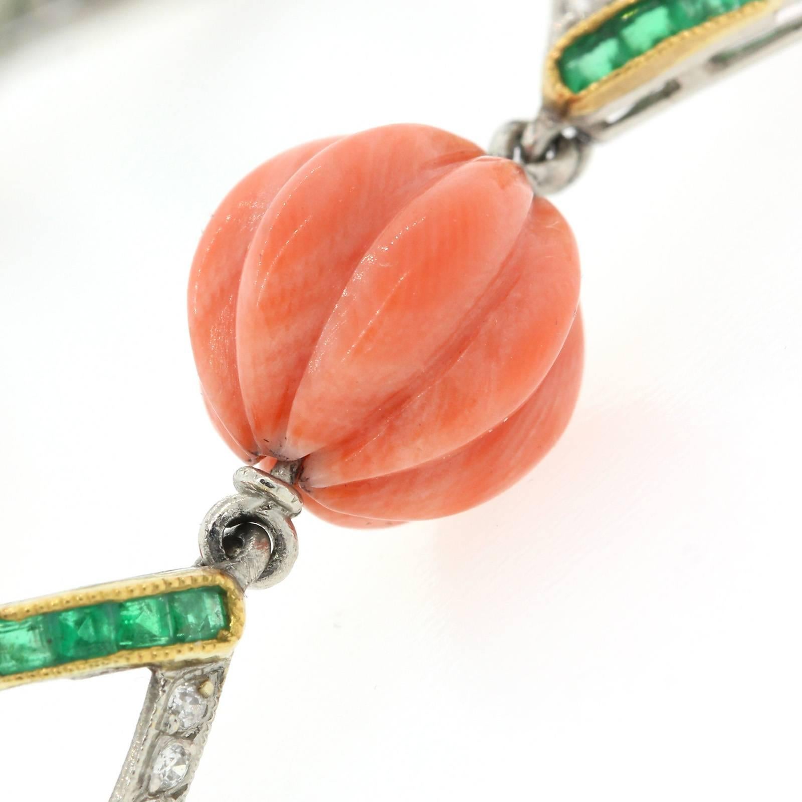 Pristine 1930s fluted Coral beads bracelet.  This beautiful Deco bracelet is comprised of seven carved Coral beads, joined by seven rhombus links.  Each link is set with eight Old European cut diamonds and eight calibrated Emeralds.   It is Gorgeous!