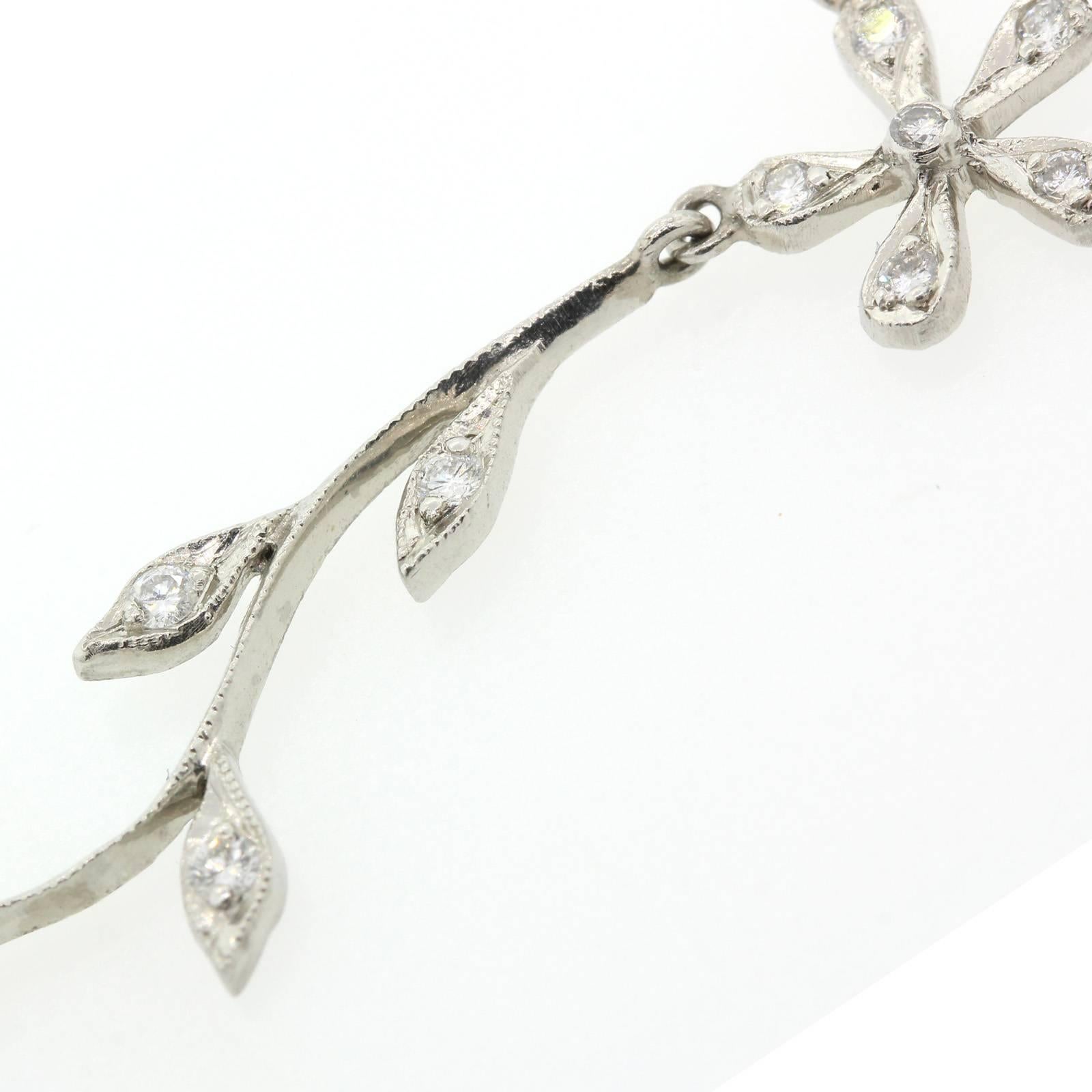 Quintessential Cathy Waterman diamond and platinum daisy and flowing leaf  necklace.  This sixteen inch long necklace is composed of ten daises joined by eleven flowing leafy vines.  It is set with approximately 2.00 carats of Round Brilliant cut